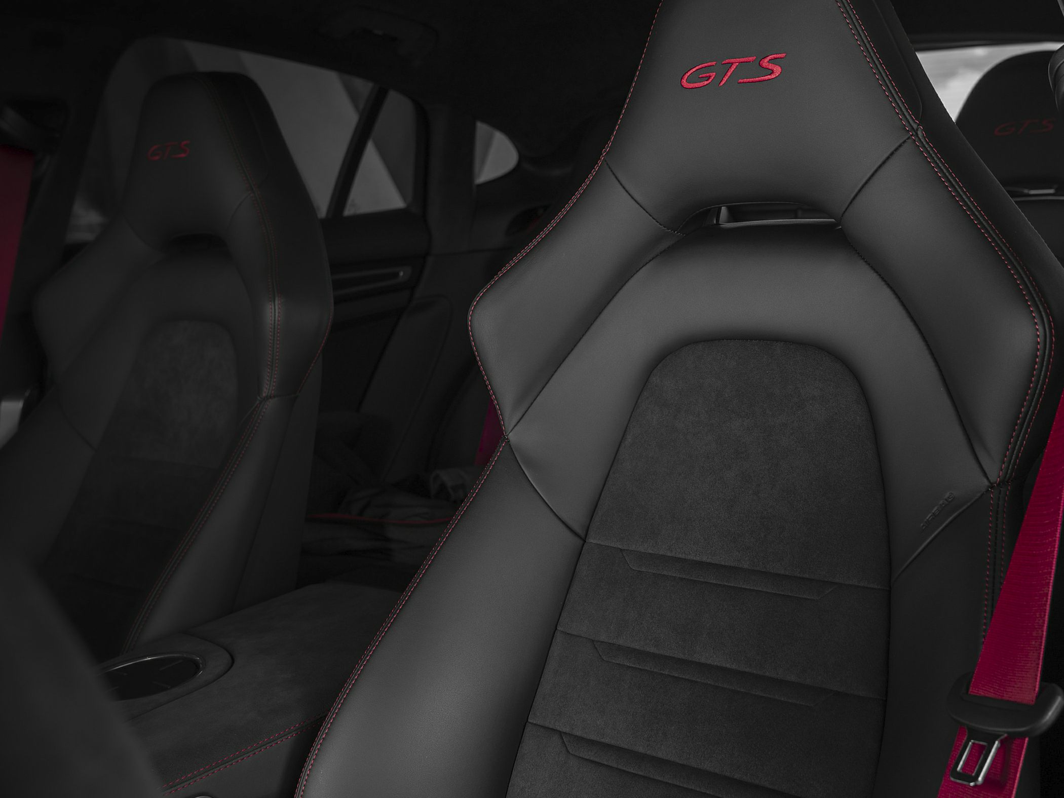 Black leather and Alcantara GTS bucket seats with red stitching and red seatbelt