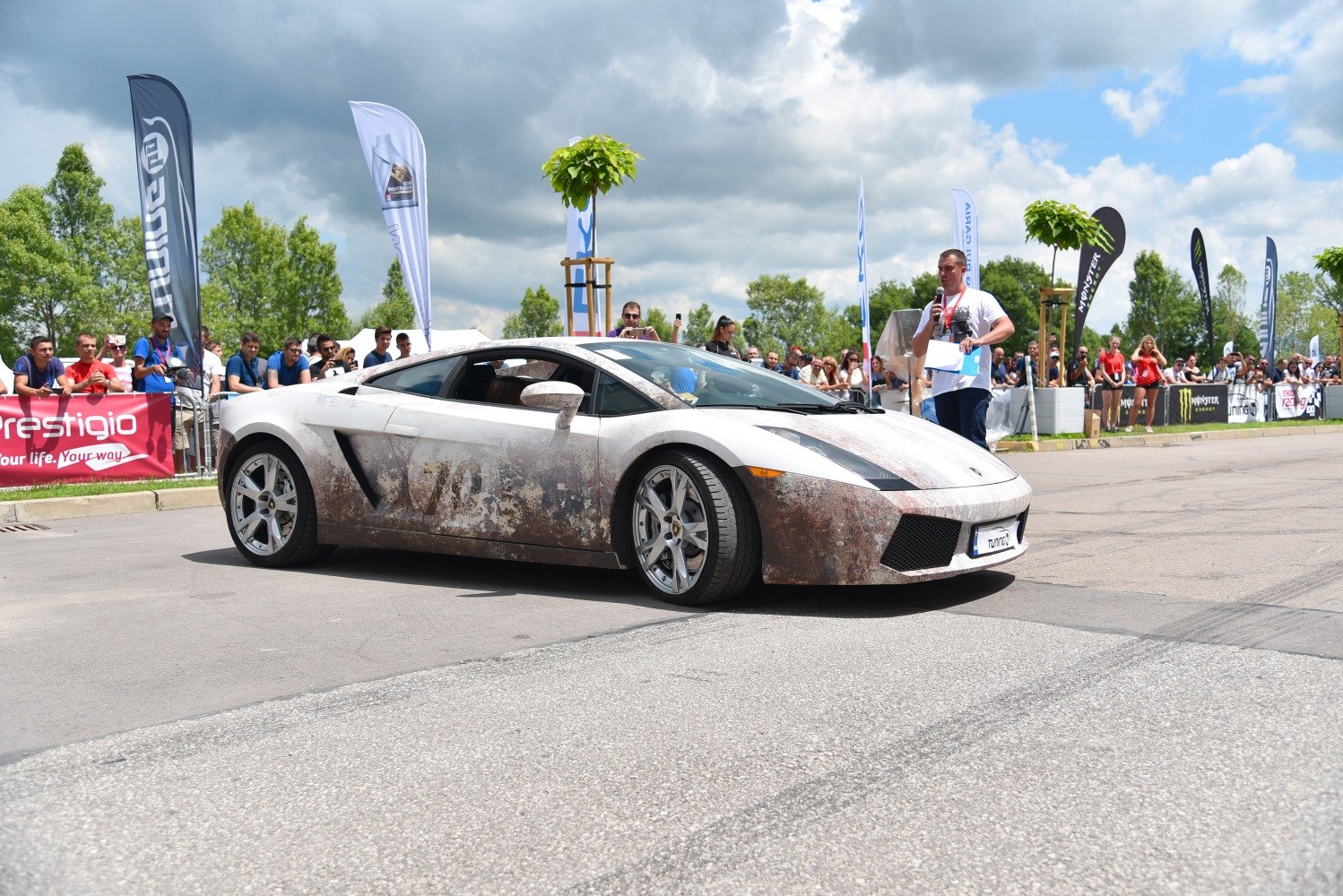 Lamborghini coupe with rusty, weathered exterior at car event