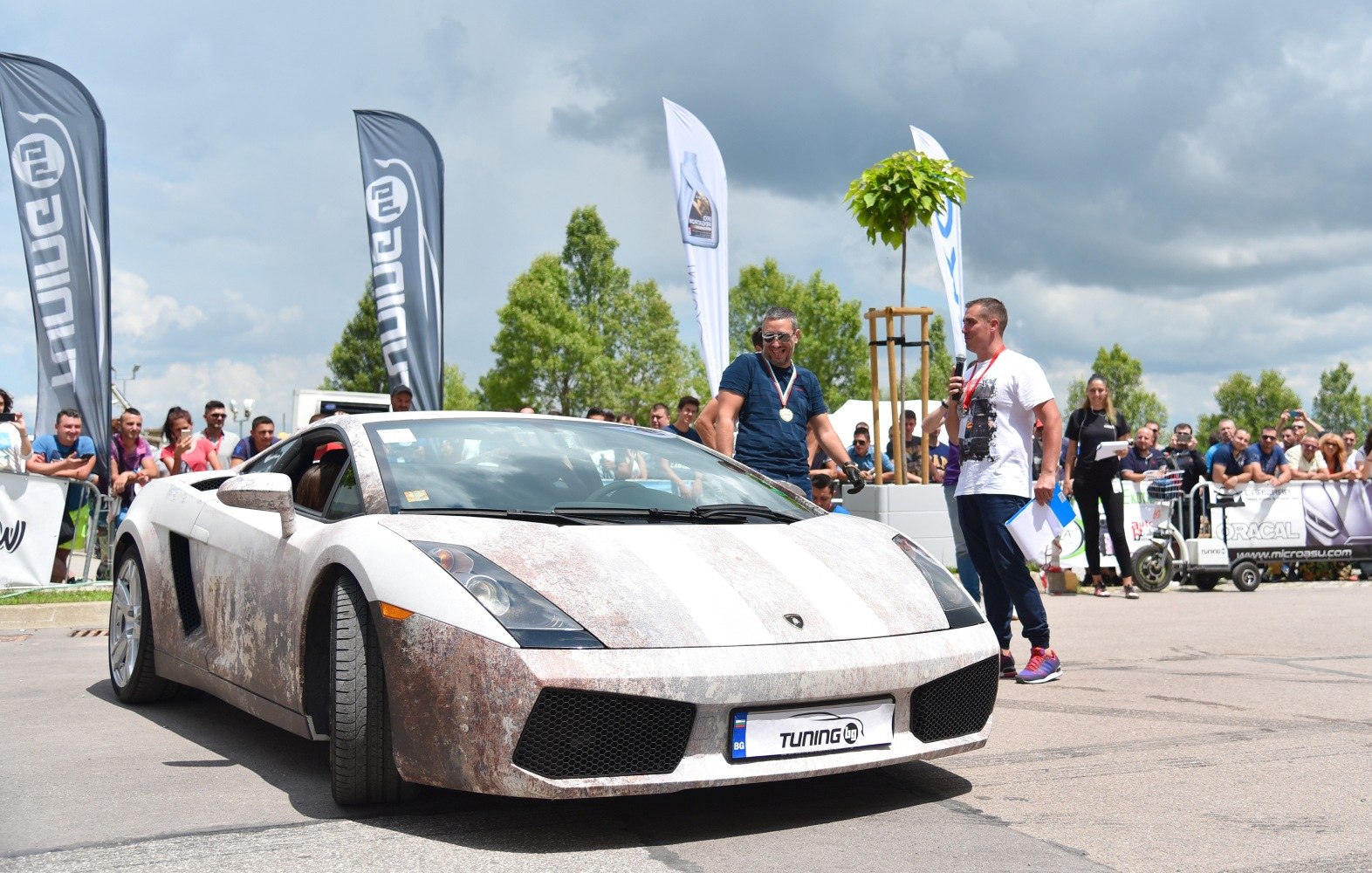 Lamborghini coupe with rusty patina wrap at outdoor car event