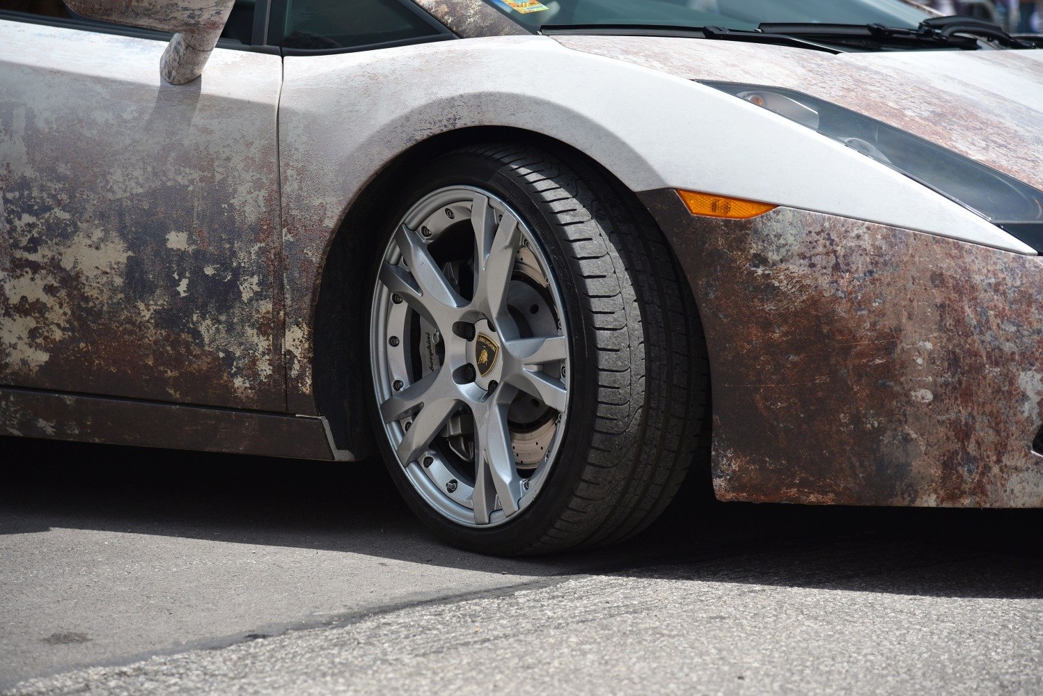 Close-up of front wheel and rust-effect exterior wrap