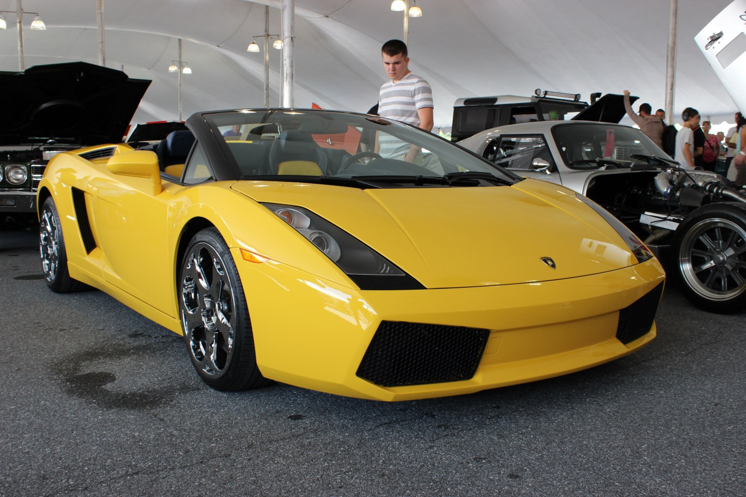 Yellow convertible sports car with angular headlights and chrome wheels