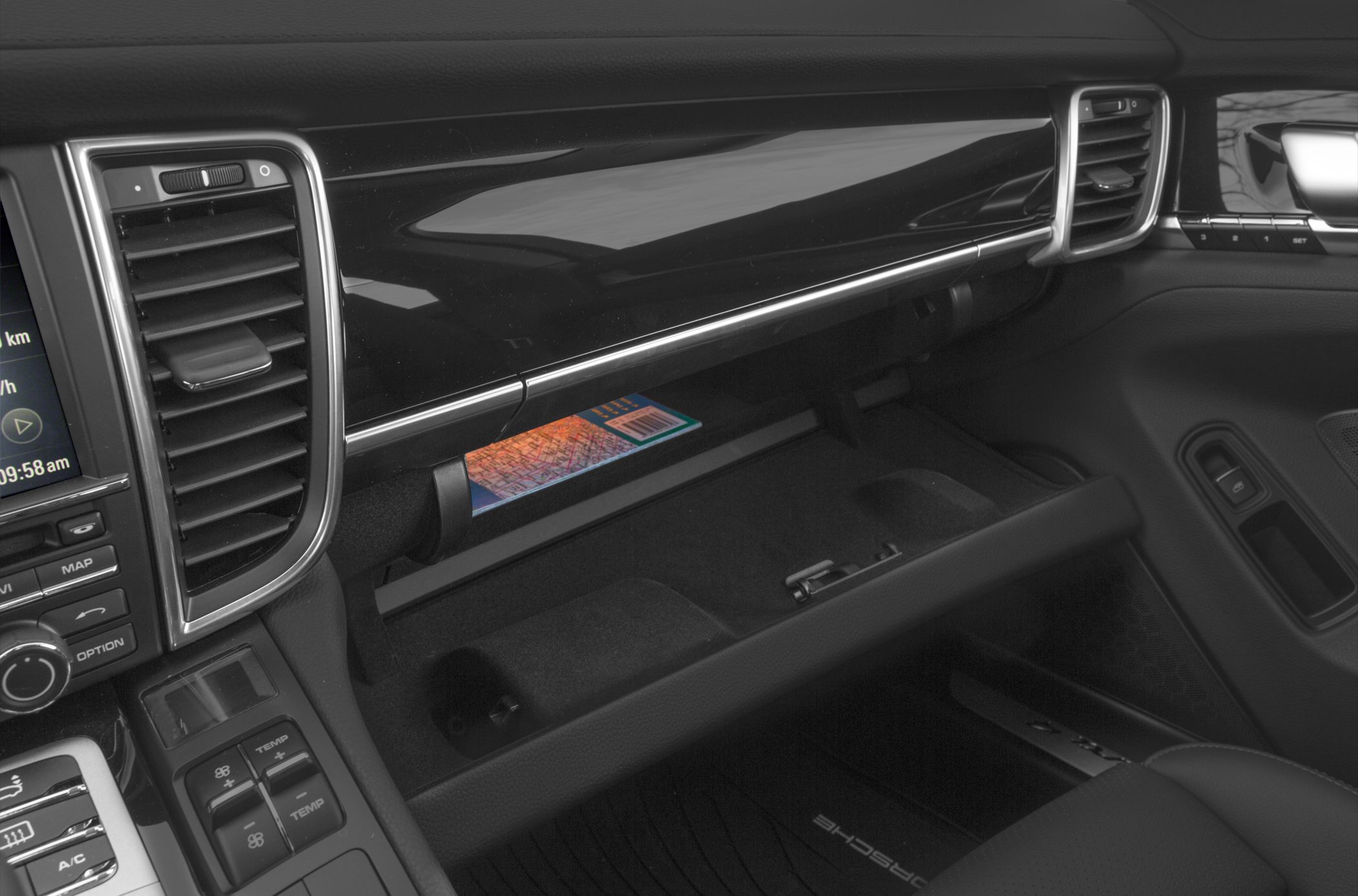 Open glove box with dashboard air vent and control buttons