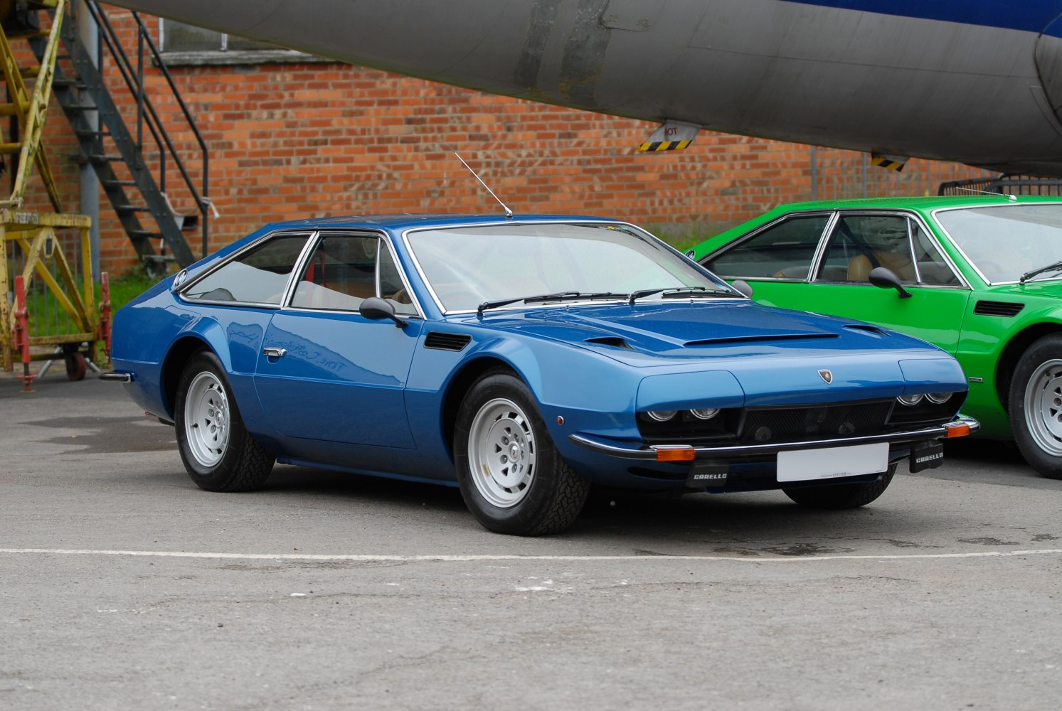 Blue classic coupe with angular front side and retro wheels