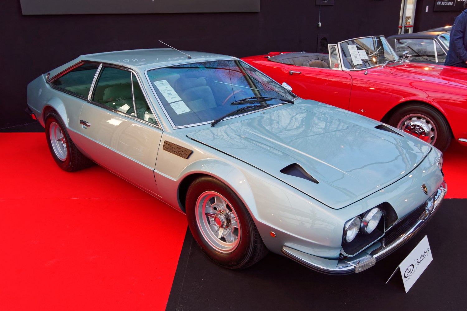 Vintage sports coupe with dual round headlights and angular body design