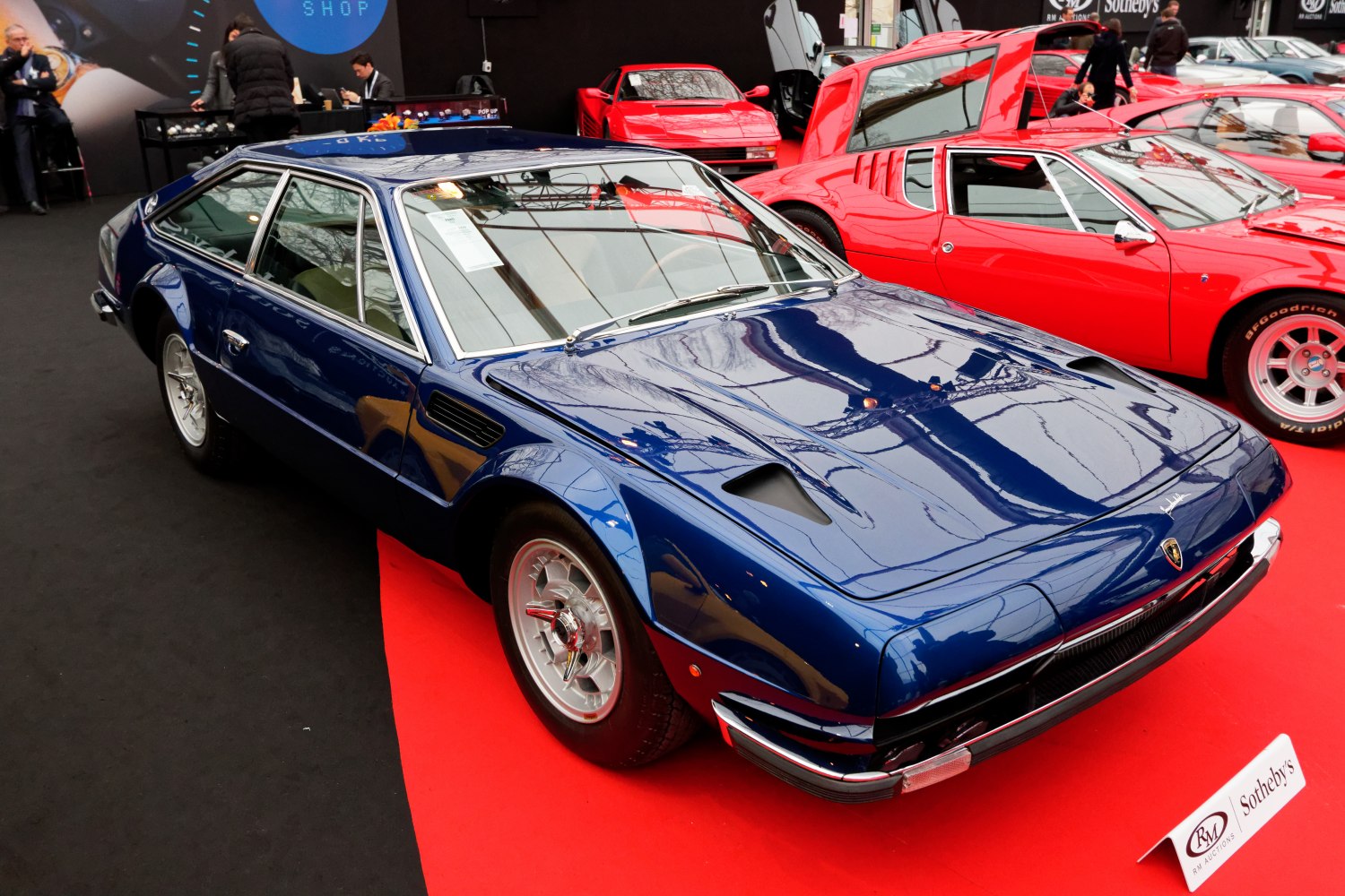 Vintage sports coupe with hood vents and chrome wheels