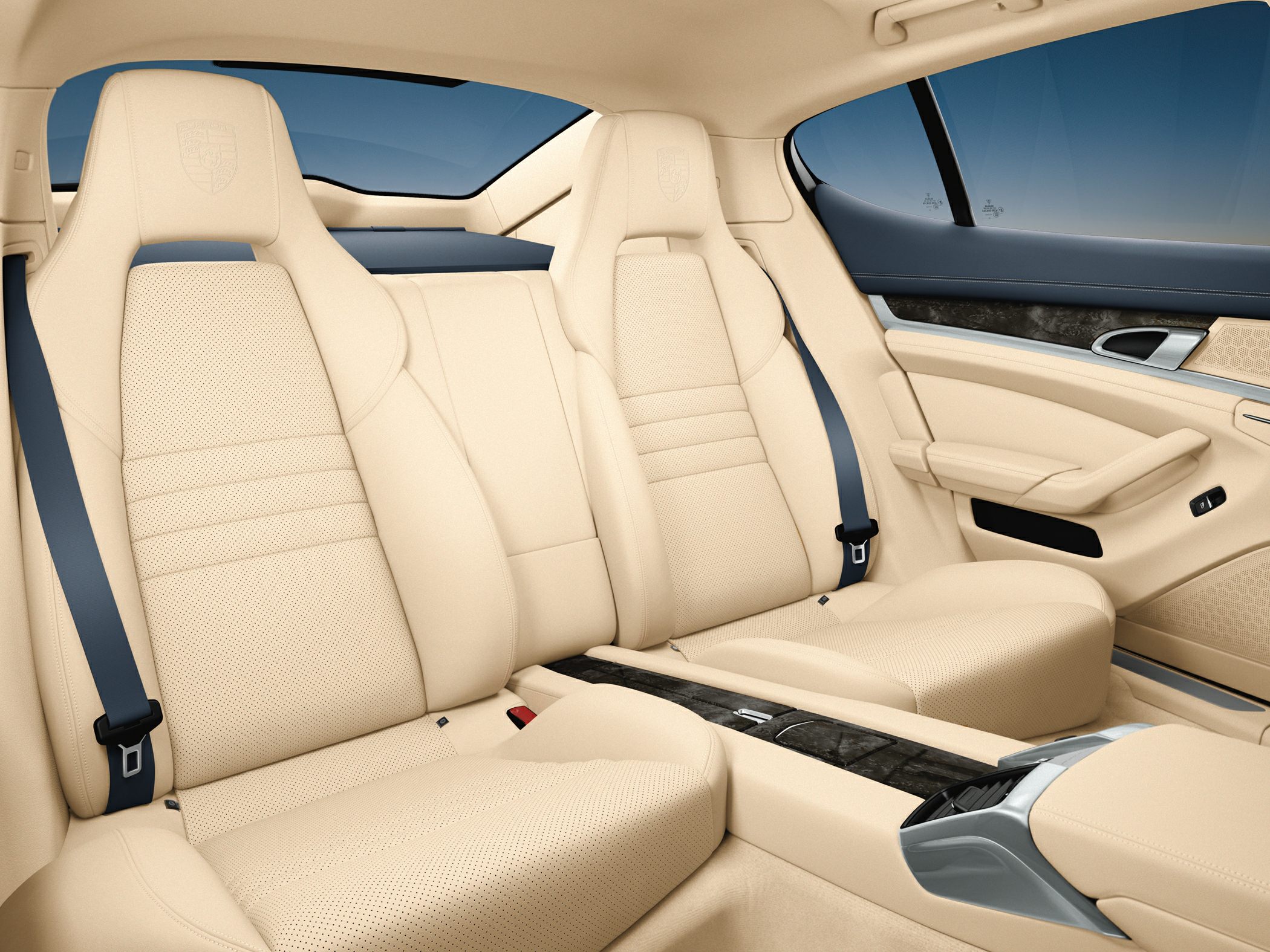 Beige leather rear seats with integrated center console and luxury design.