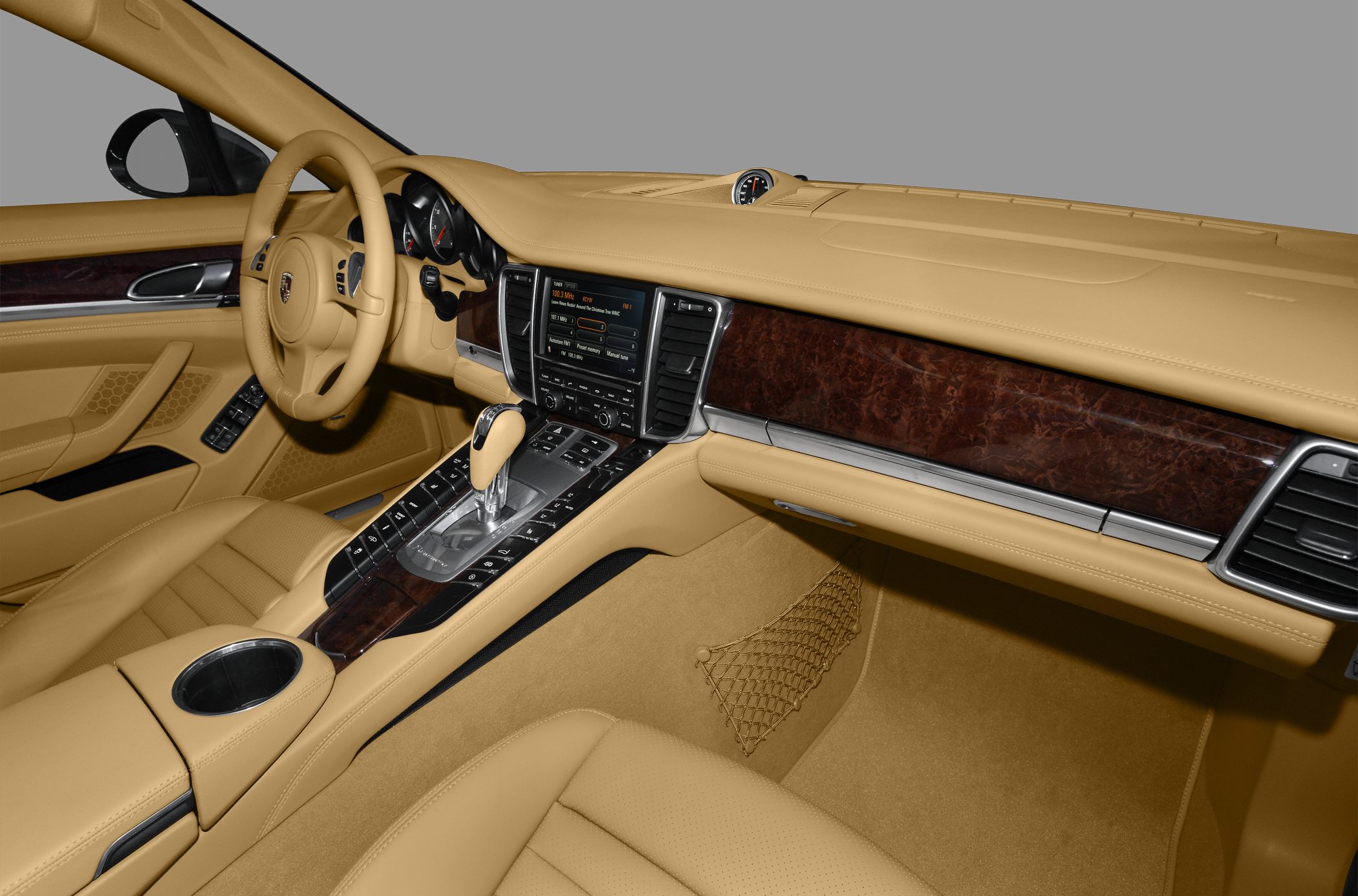 Beige leather cabin with wood trim and advanced center console