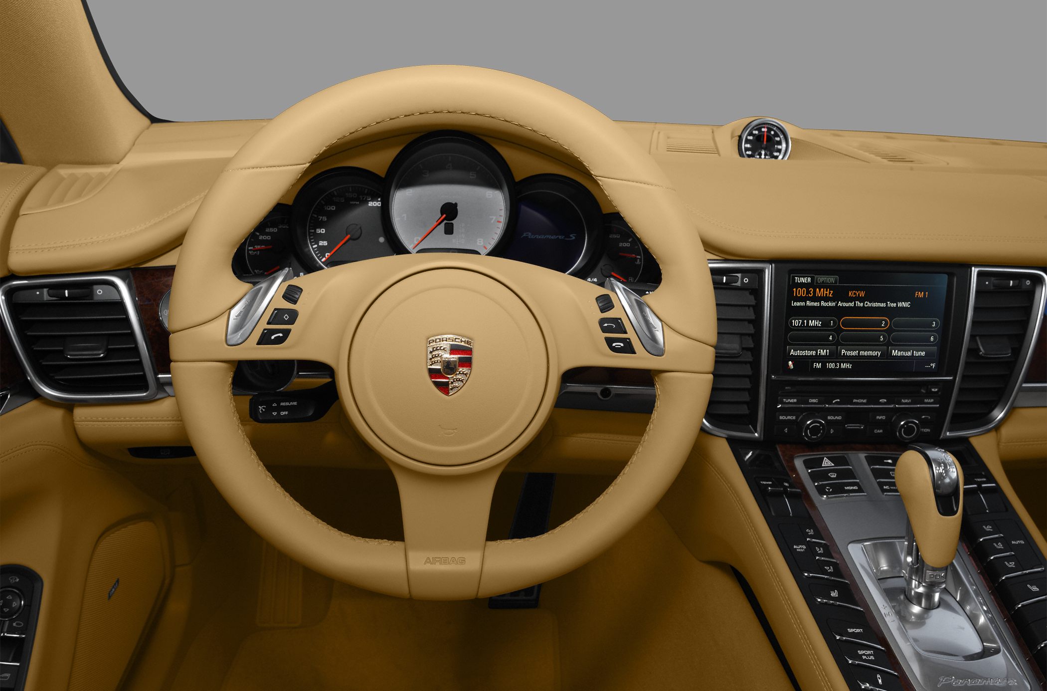 Beige leather interior with dashboard, steering wheel, and console controls