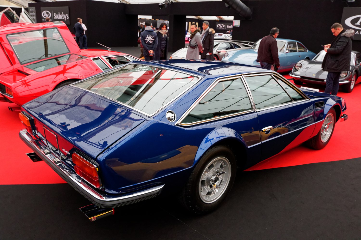 Rear and side profile of a classic angular sports coupe with vintage alloy wheels