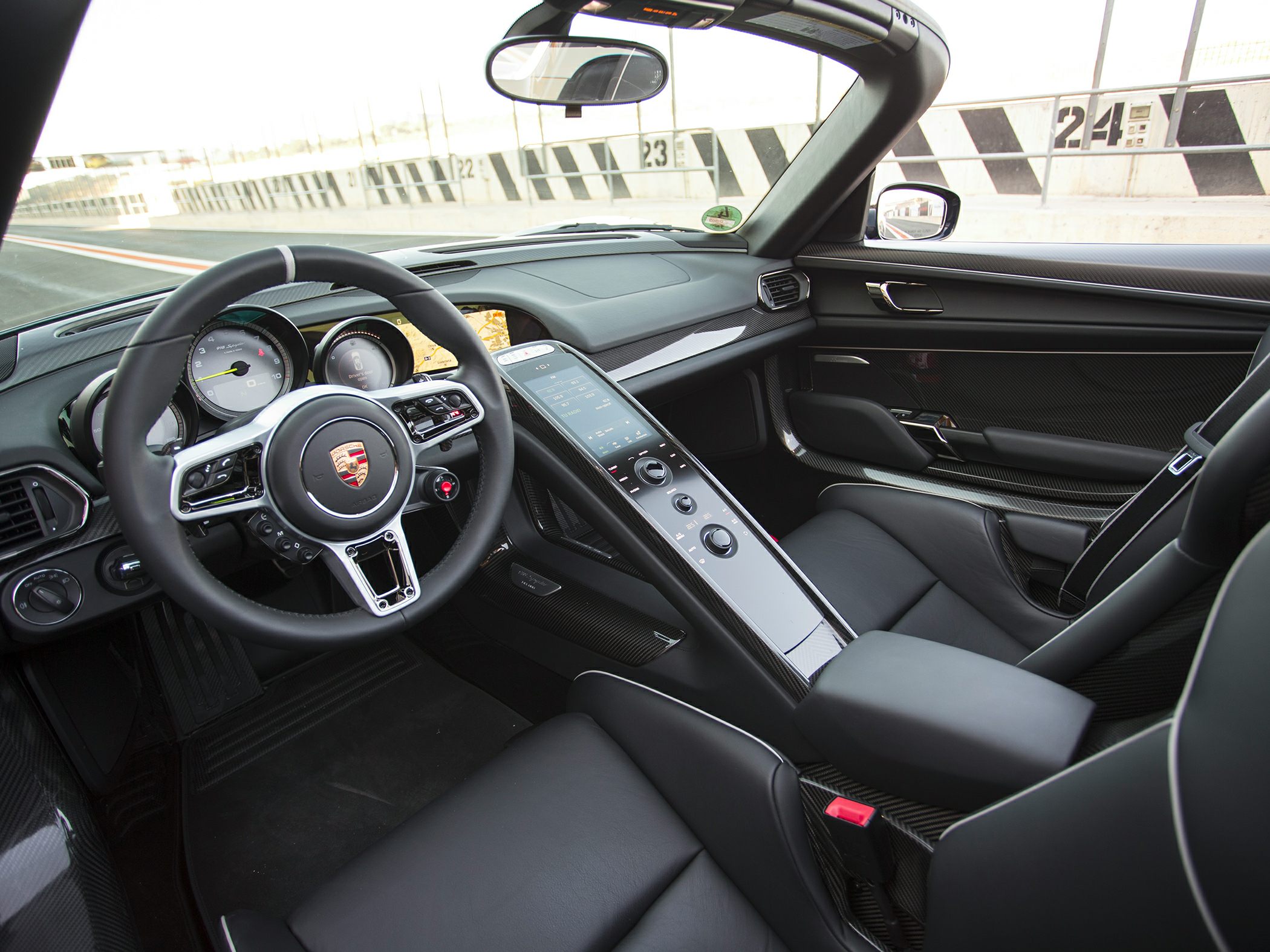 Carbon fiber trim and advanced center console inside a sports car cockpit