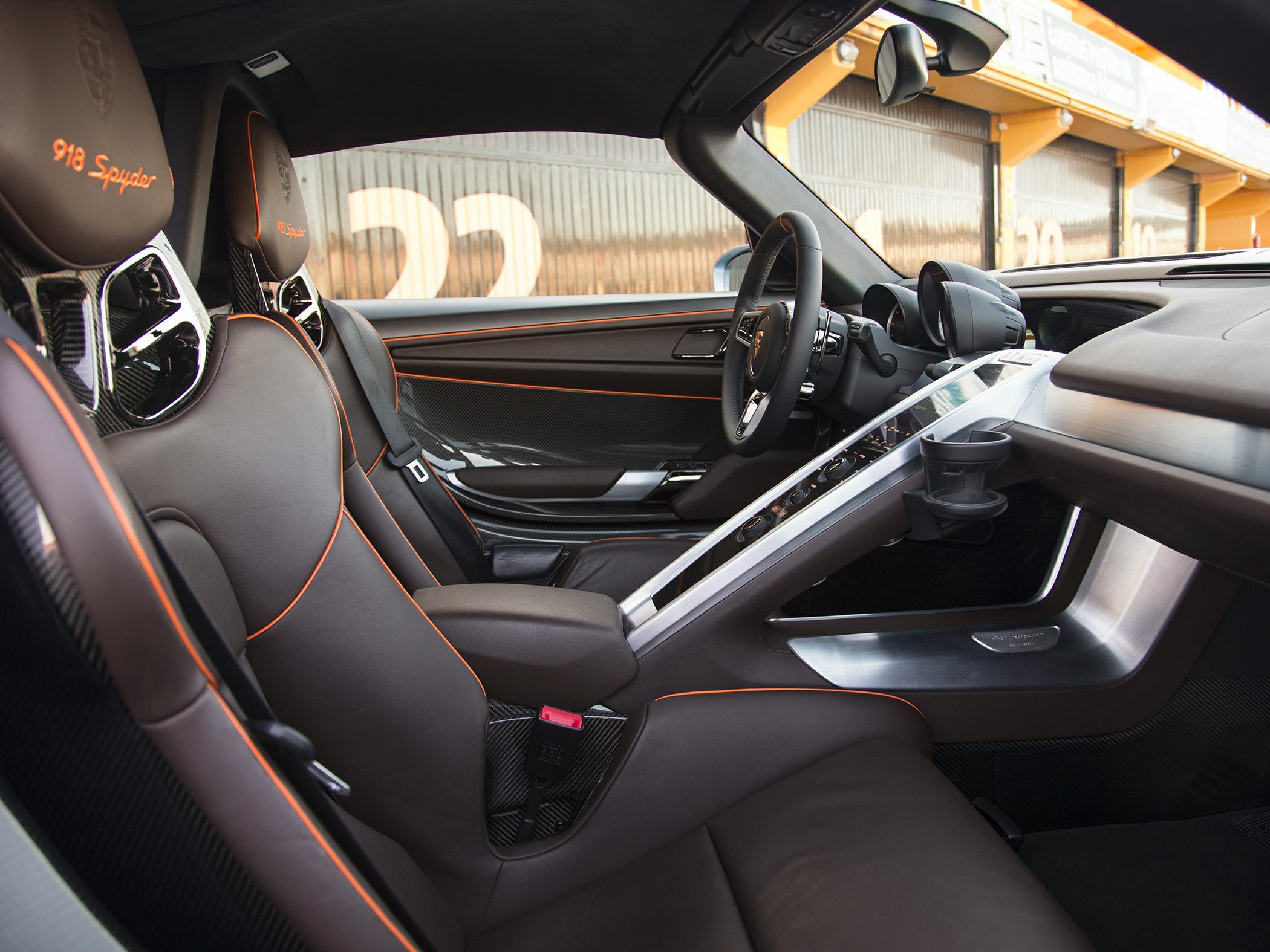 Brown leather seats with orange stitching and carbon fiber interior trim