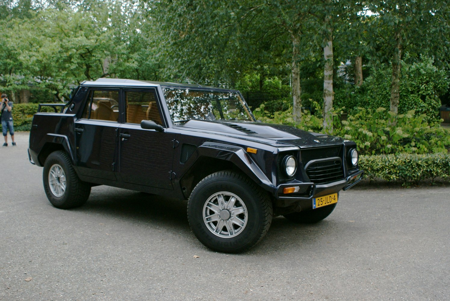 Classic angular SUV front-side view with round headlights and rugged tires