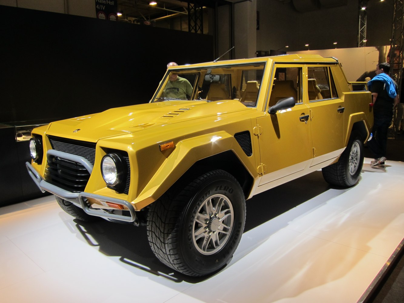 Angular yellow SUV with off-road tires and robust front guard