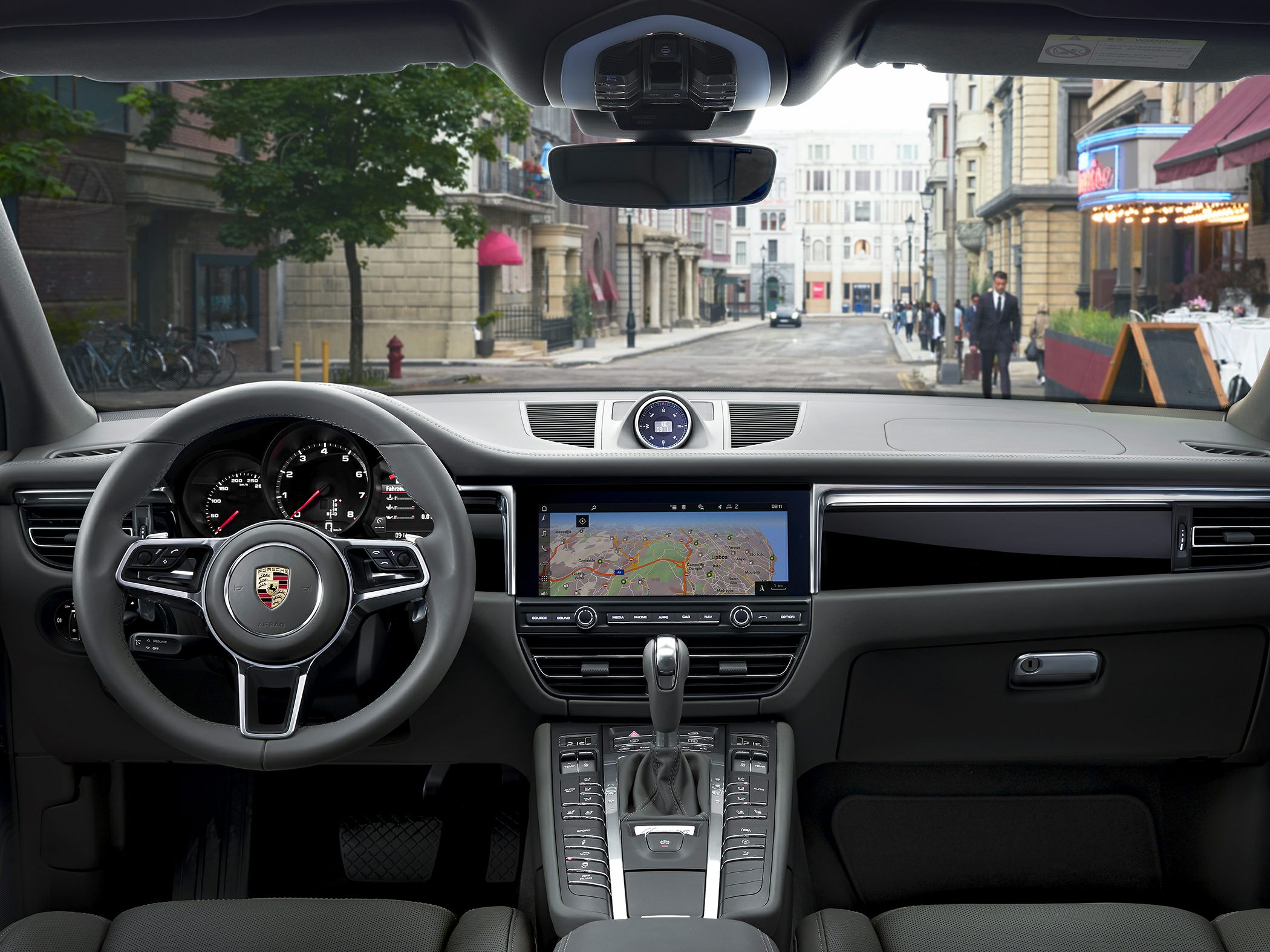 Luxury interior dashboard with digital navigation and multi-function steering wheel.