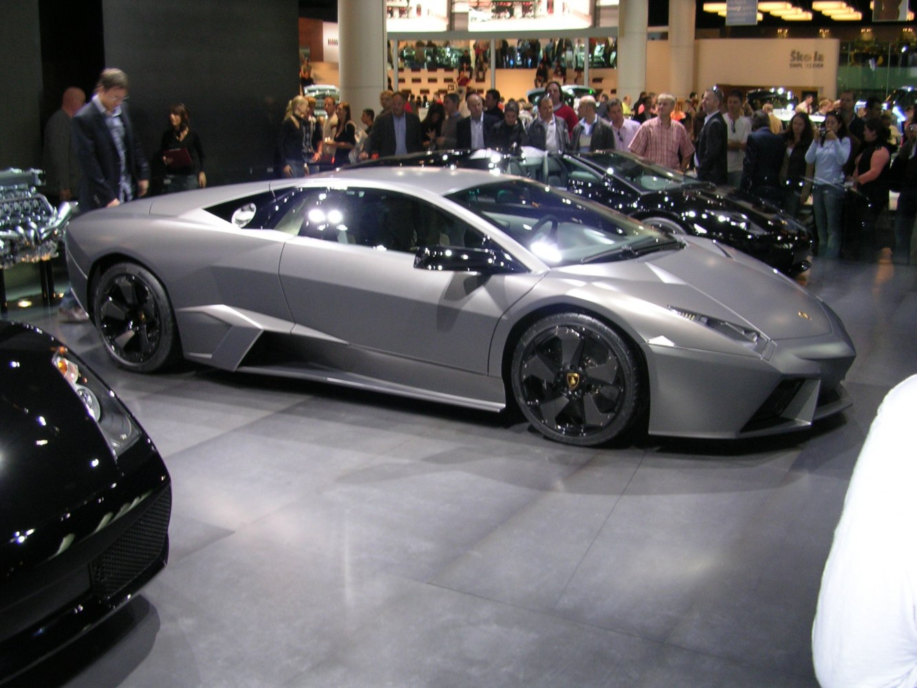 Sleek side profile of a matte-finished supercar with distinctive black wheels
