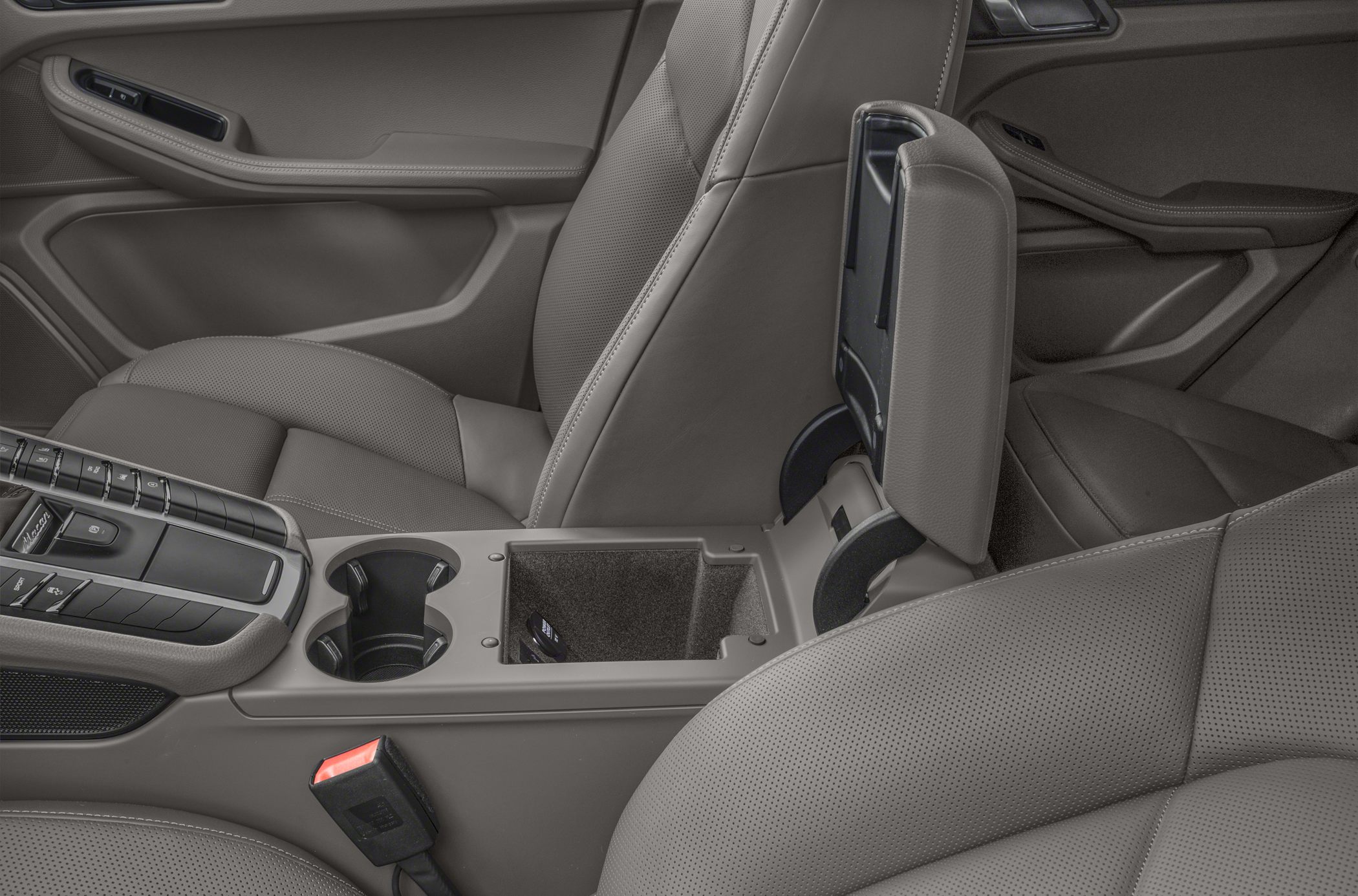 Center console with open storage and sport seats in perforated leather upholstery.