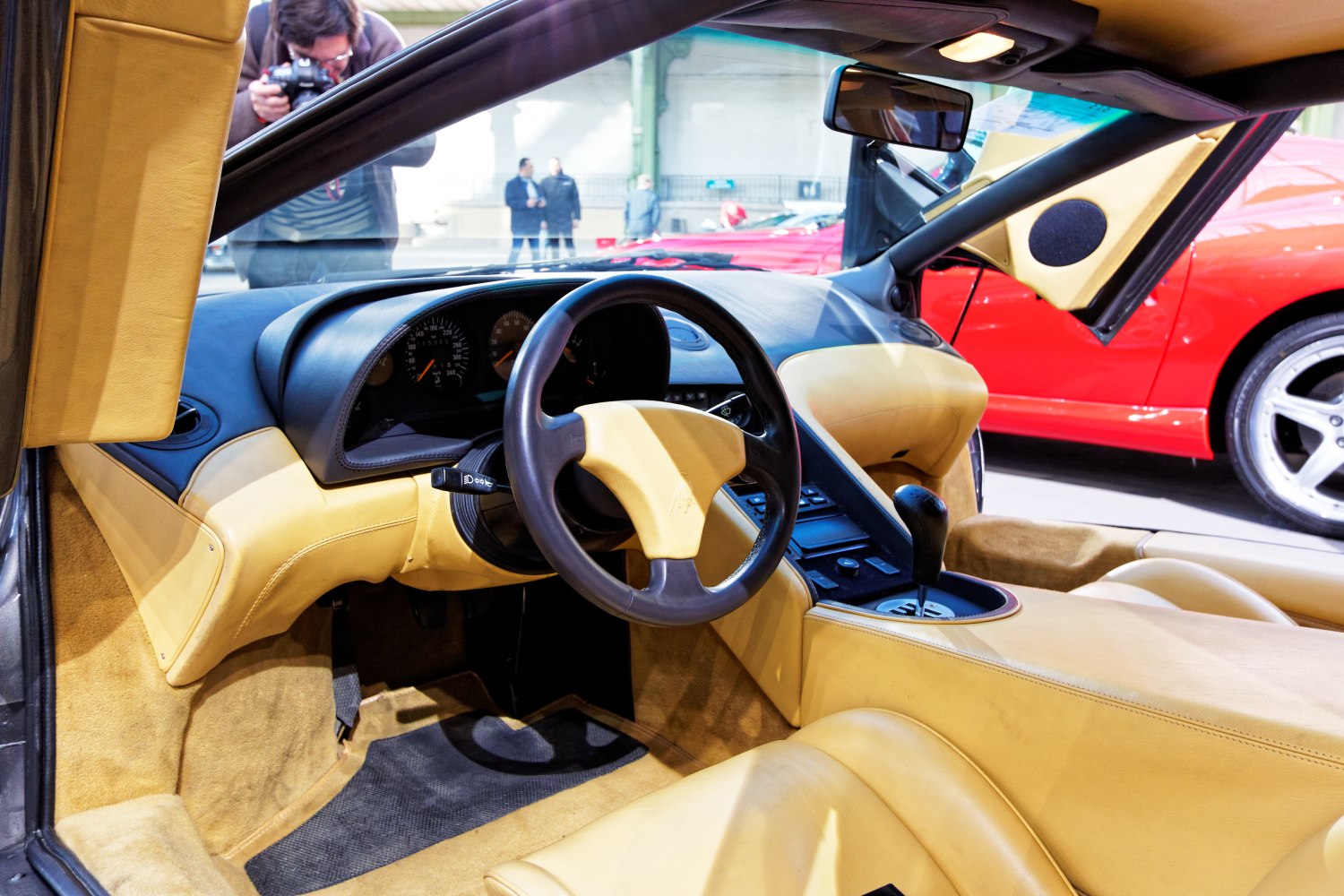 Close-up of steering wheel, dashboard, and tan leather interior