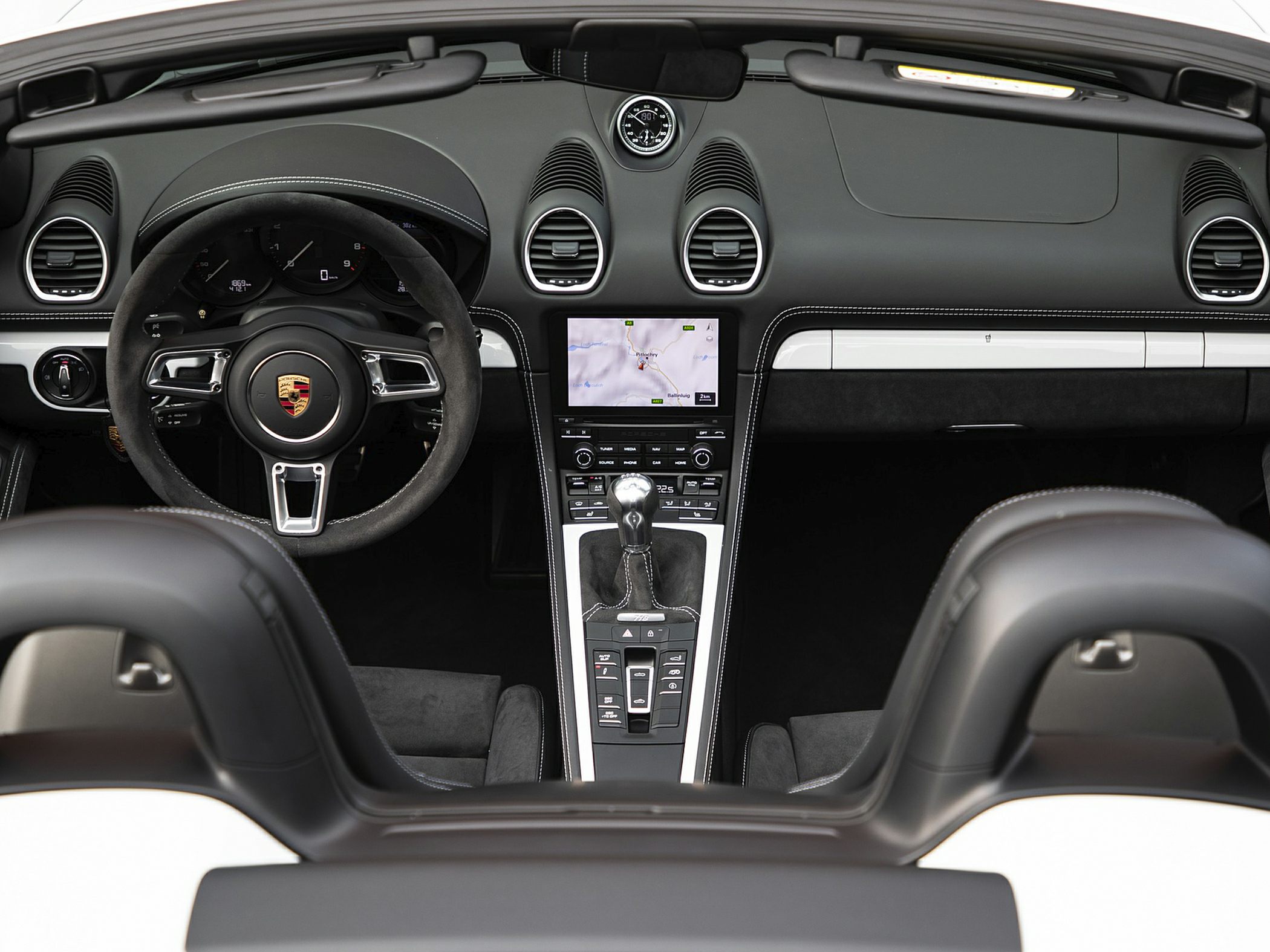 Sporty steering wheel and manual gearshift in luxury convertible interior