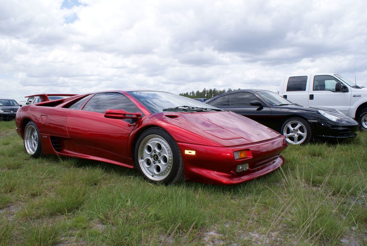 Red sports car with rear spoiler and pop-up headlights