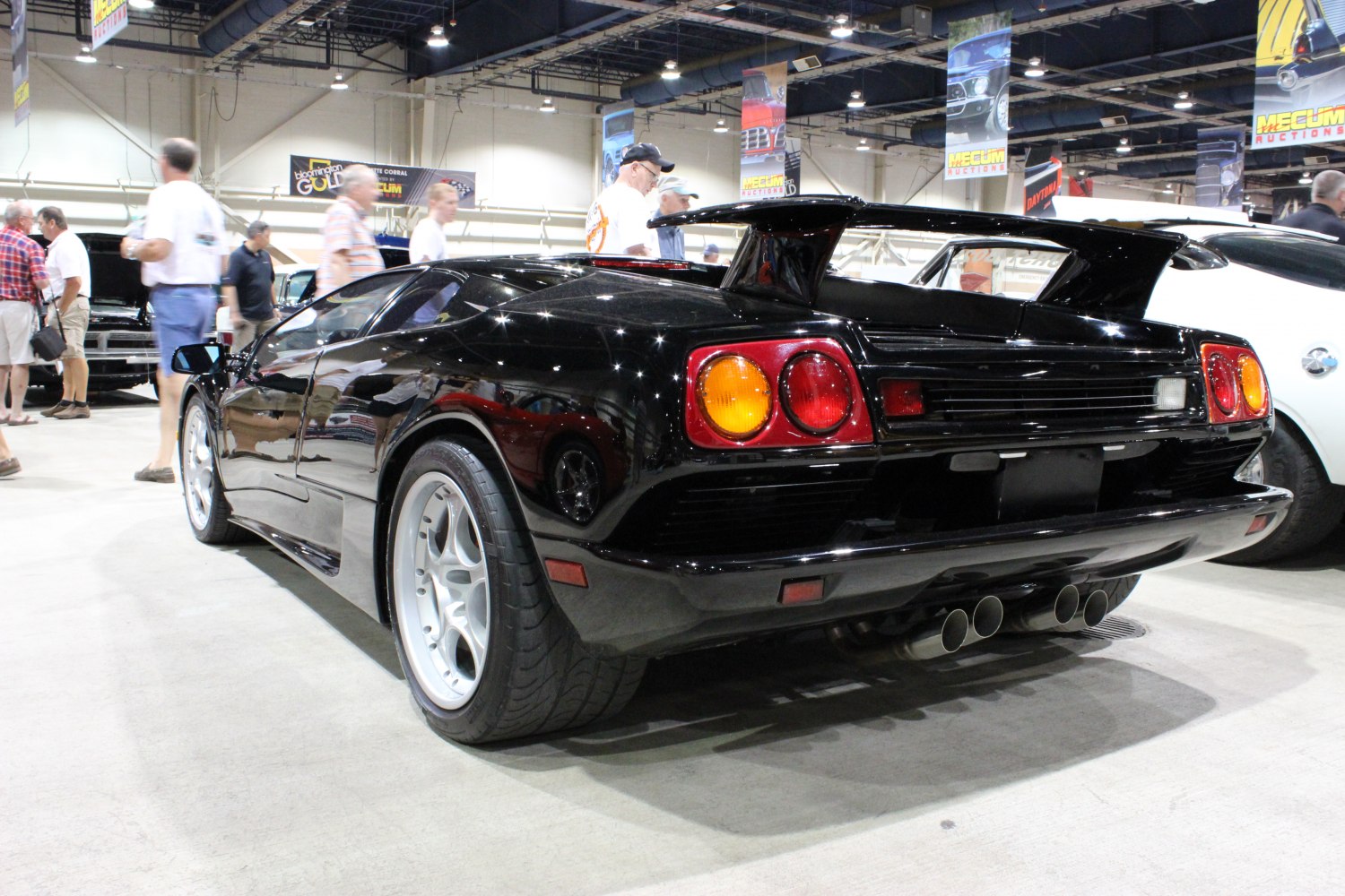Rear view of sports car with large spoiler and quad exhausts
