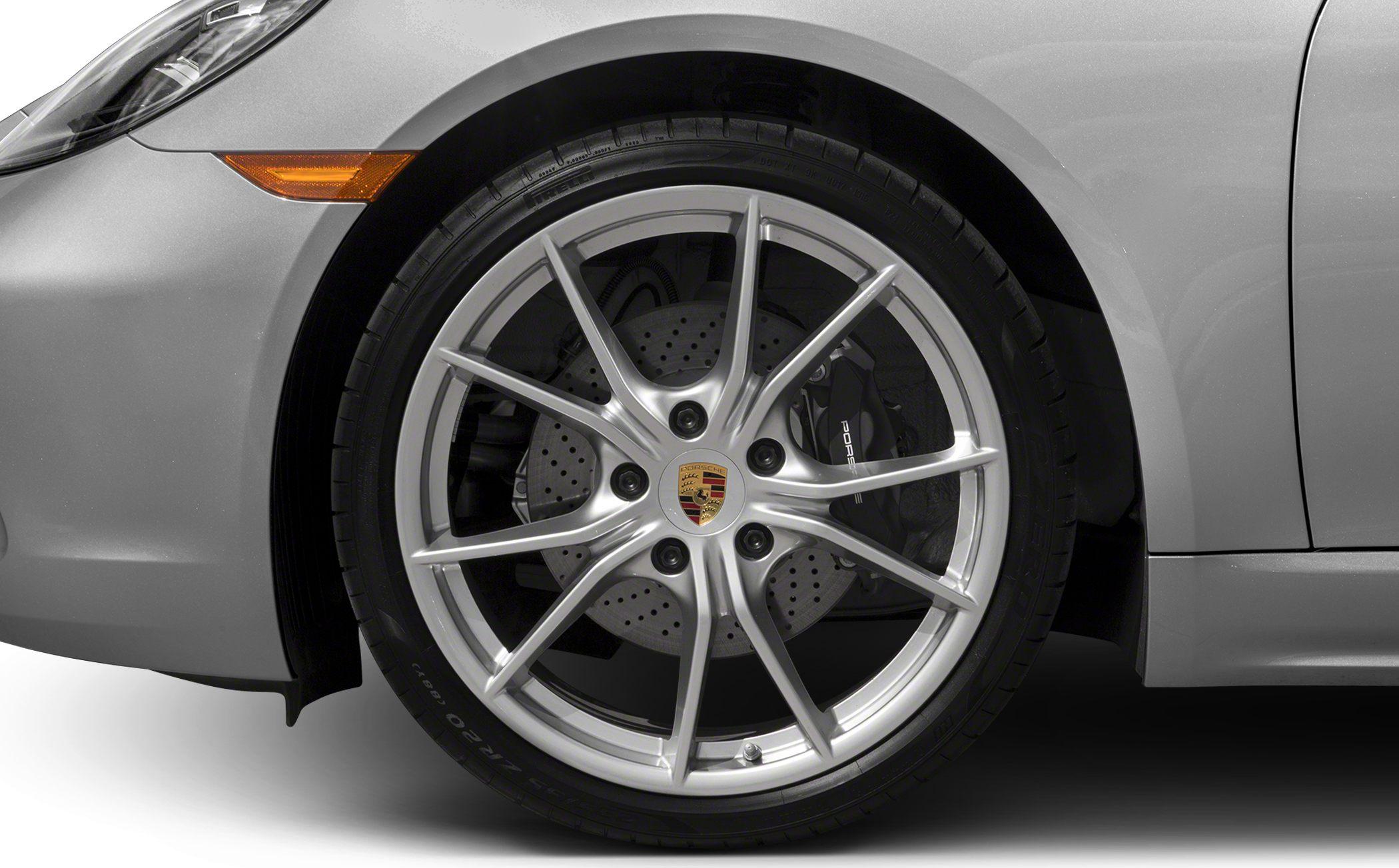 Close-up of alloy rim and perforated brake disc with caliper