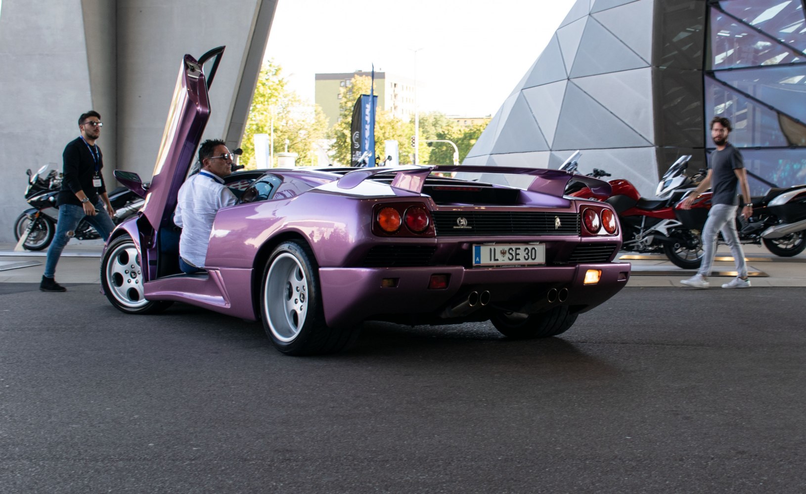 Rear view with open scissor door and distinct taillights