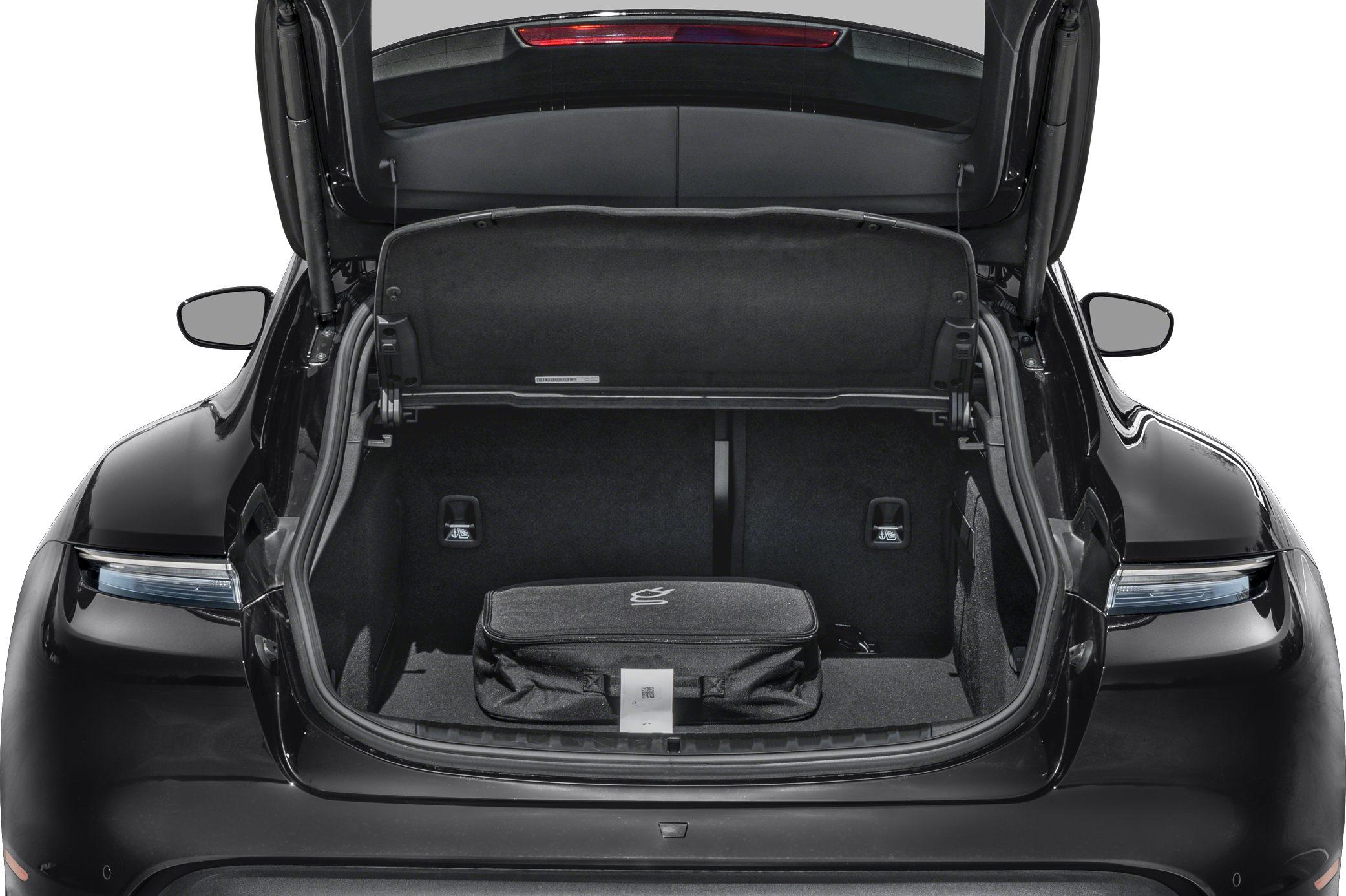 Open spacious rear trunk with luggage in black EV