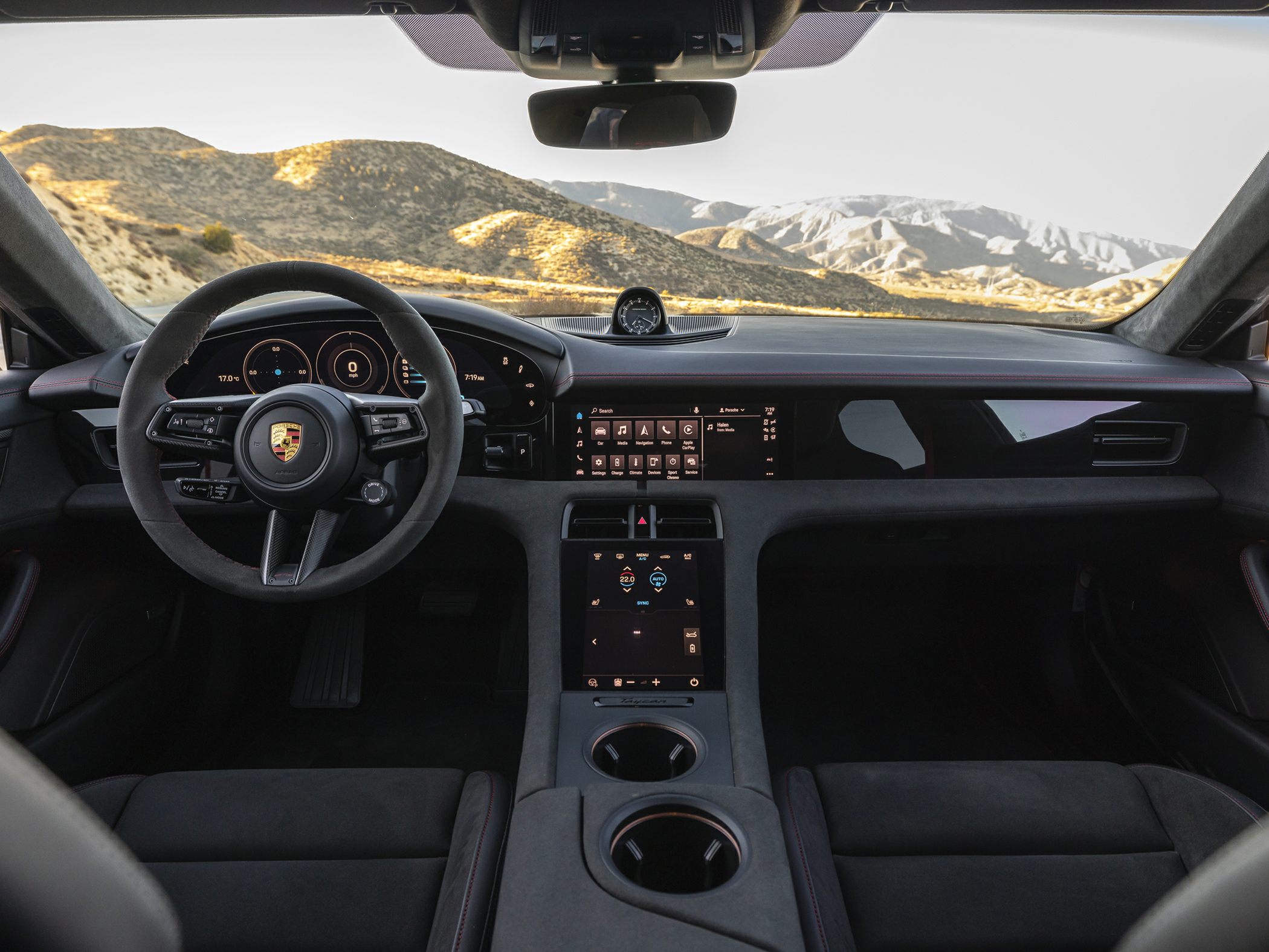 Digital dashboard, dual touchscreen panels, and sporty steering wheel in car interior