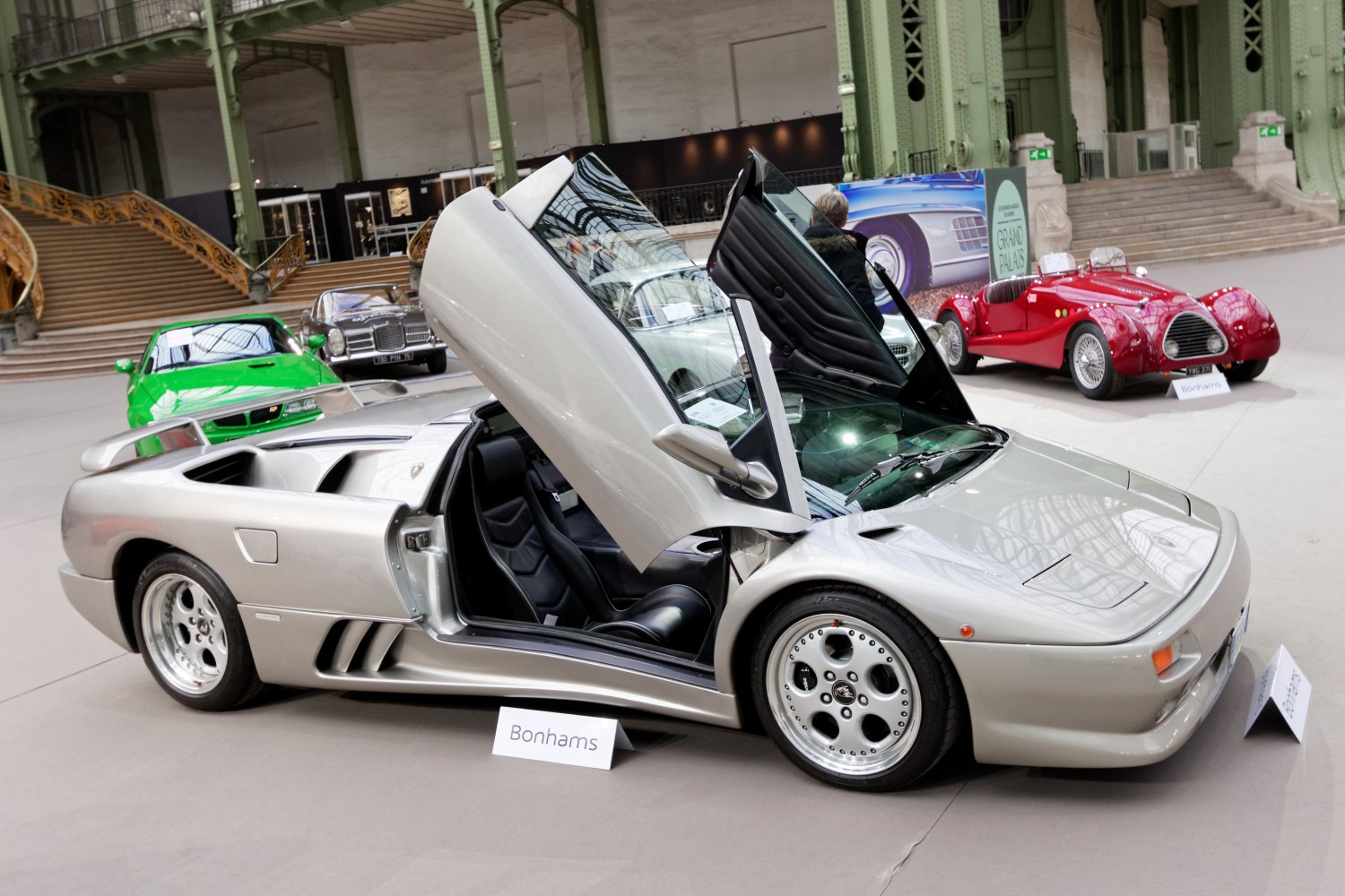 Silver roadster with open scissor doors and sleek sports styling