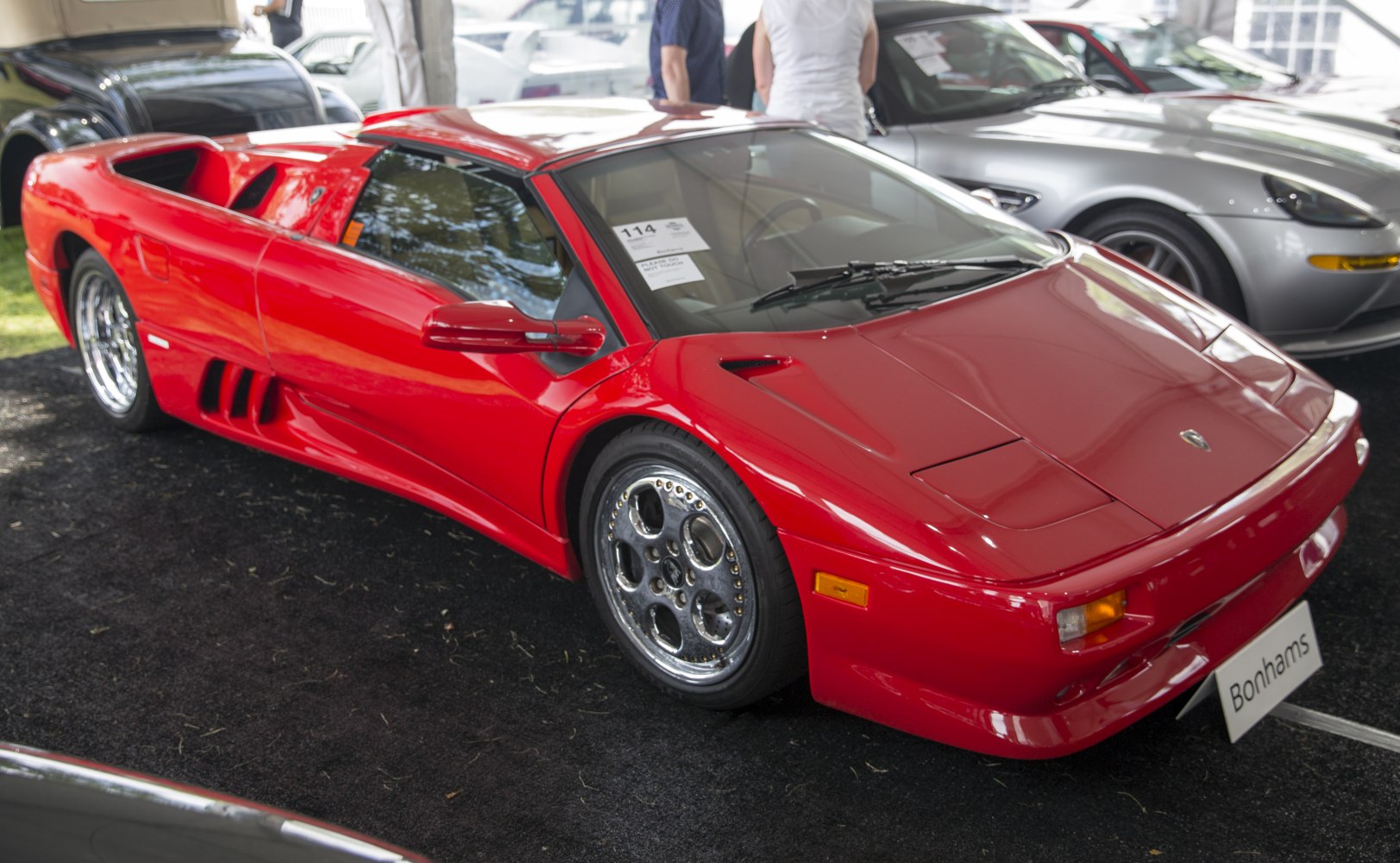 Red supercar with aerodynamic vents and sleek front-side design