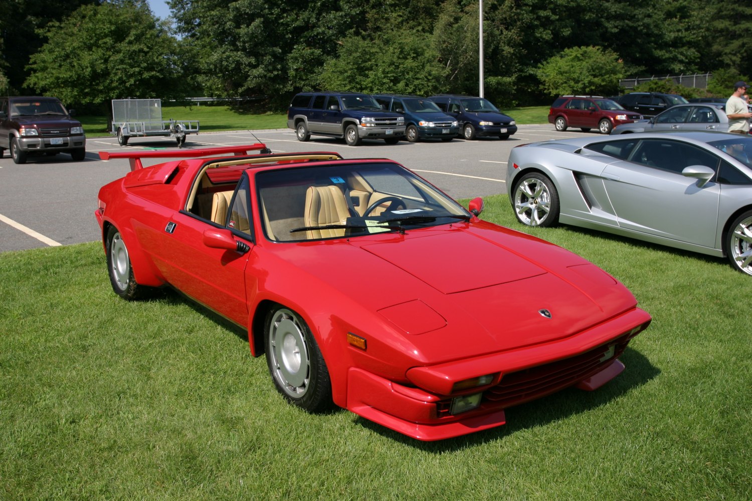 Red classic sports car with rear spoiler and targa top