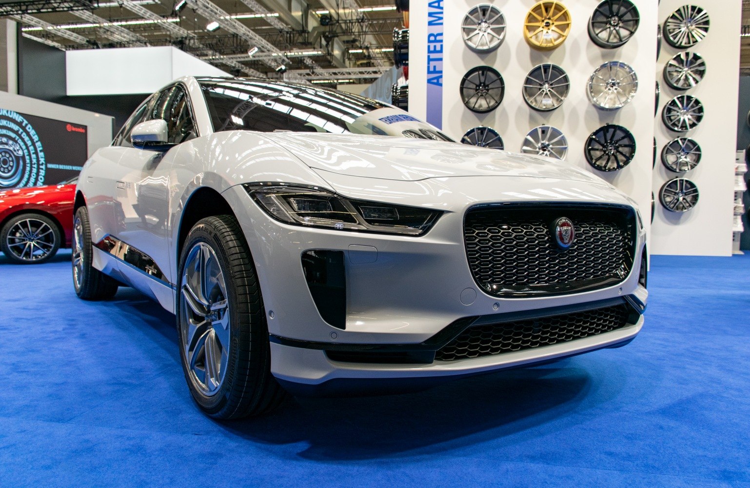 Front angled view showing grille, headlights, and wheels of white SUV