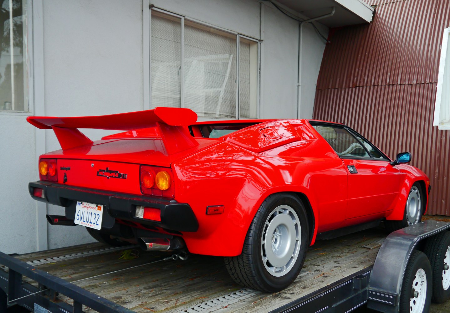 Bright red rear side with large wing spoiler and classic rear light cluster