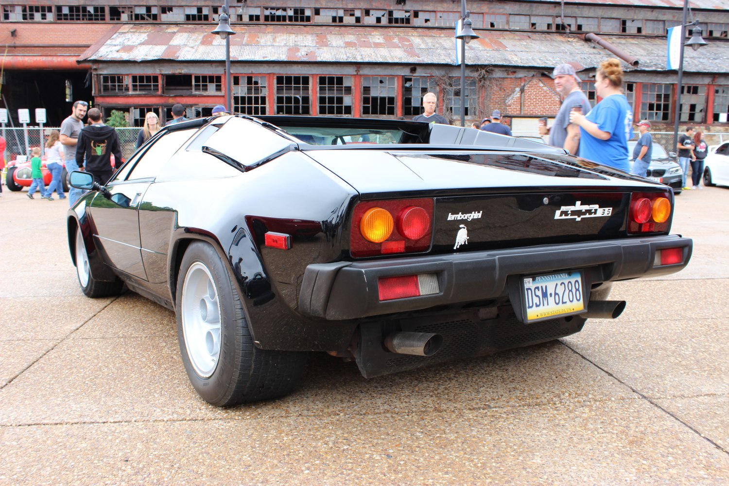 Classic 1980s sports coupe rear with taillights and dual exhaust