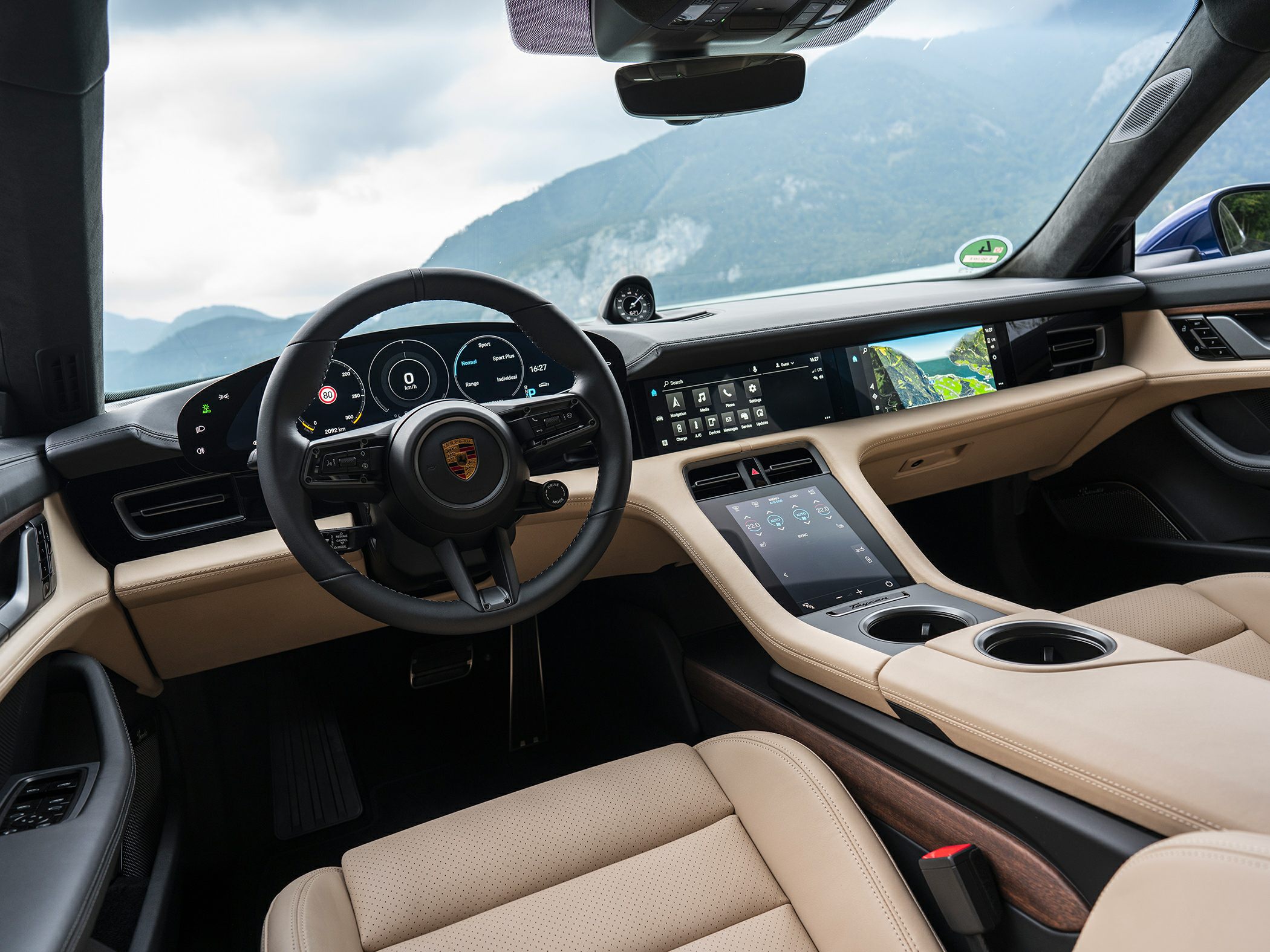 Digital instrument cluster and dual touchscreen dashboard with beige leather interior