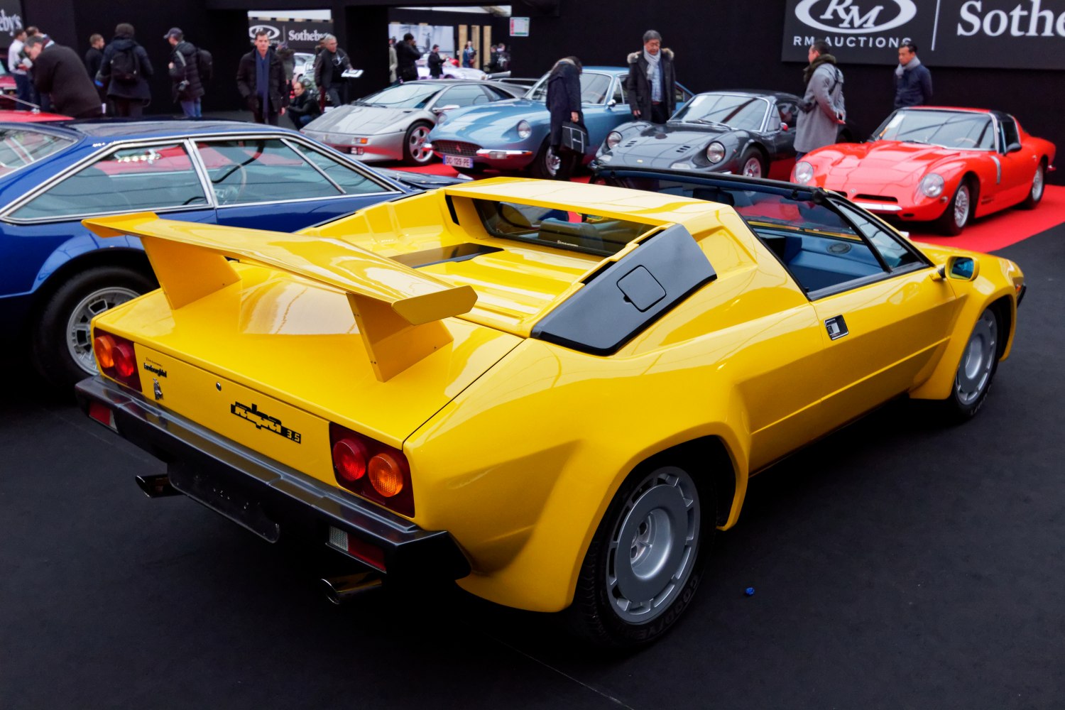 Classic yellow sports car with prominent rear wing and angular rear design