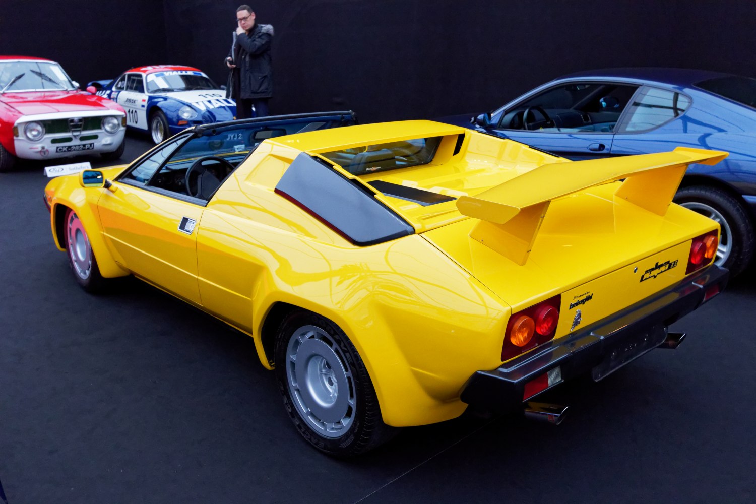 Yellow sports car with large rear wing and angular wedge-shaped design