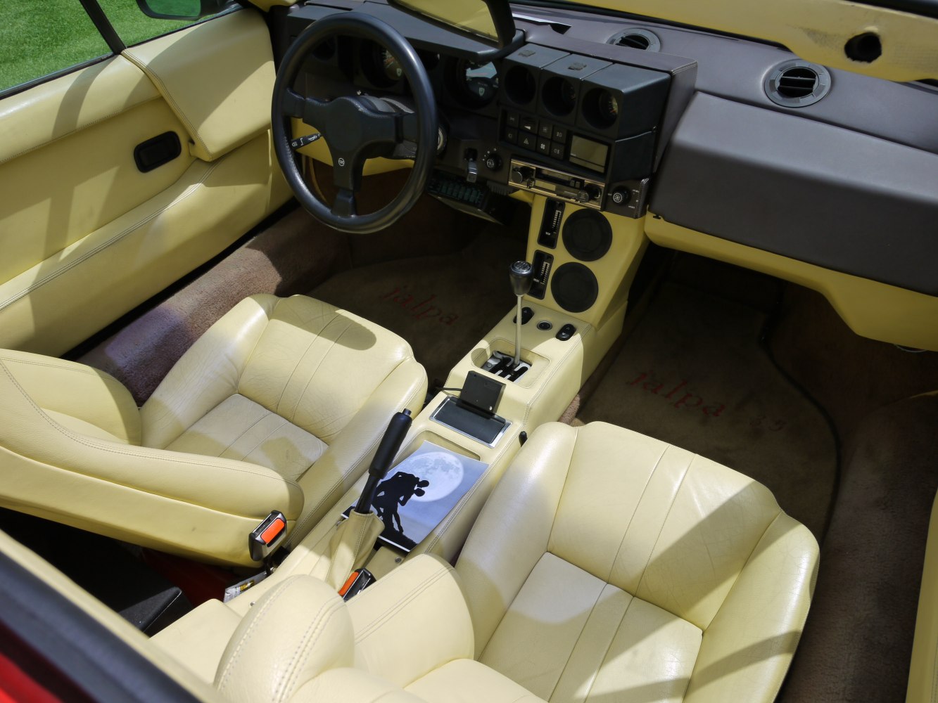 Beige leather interior with manual gearshift and vintage dashboard