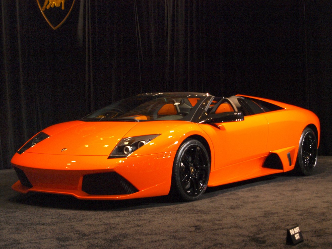 Orange Lamborghini Murcielago LP640 Roadster with black rims shown from front-side