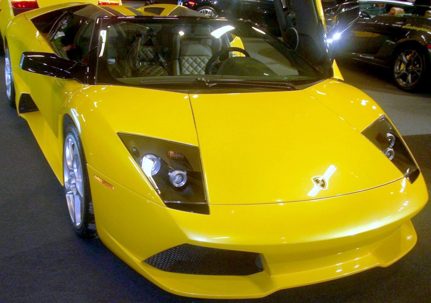 Yellow sports car front with angular headlights and aerodynamic design