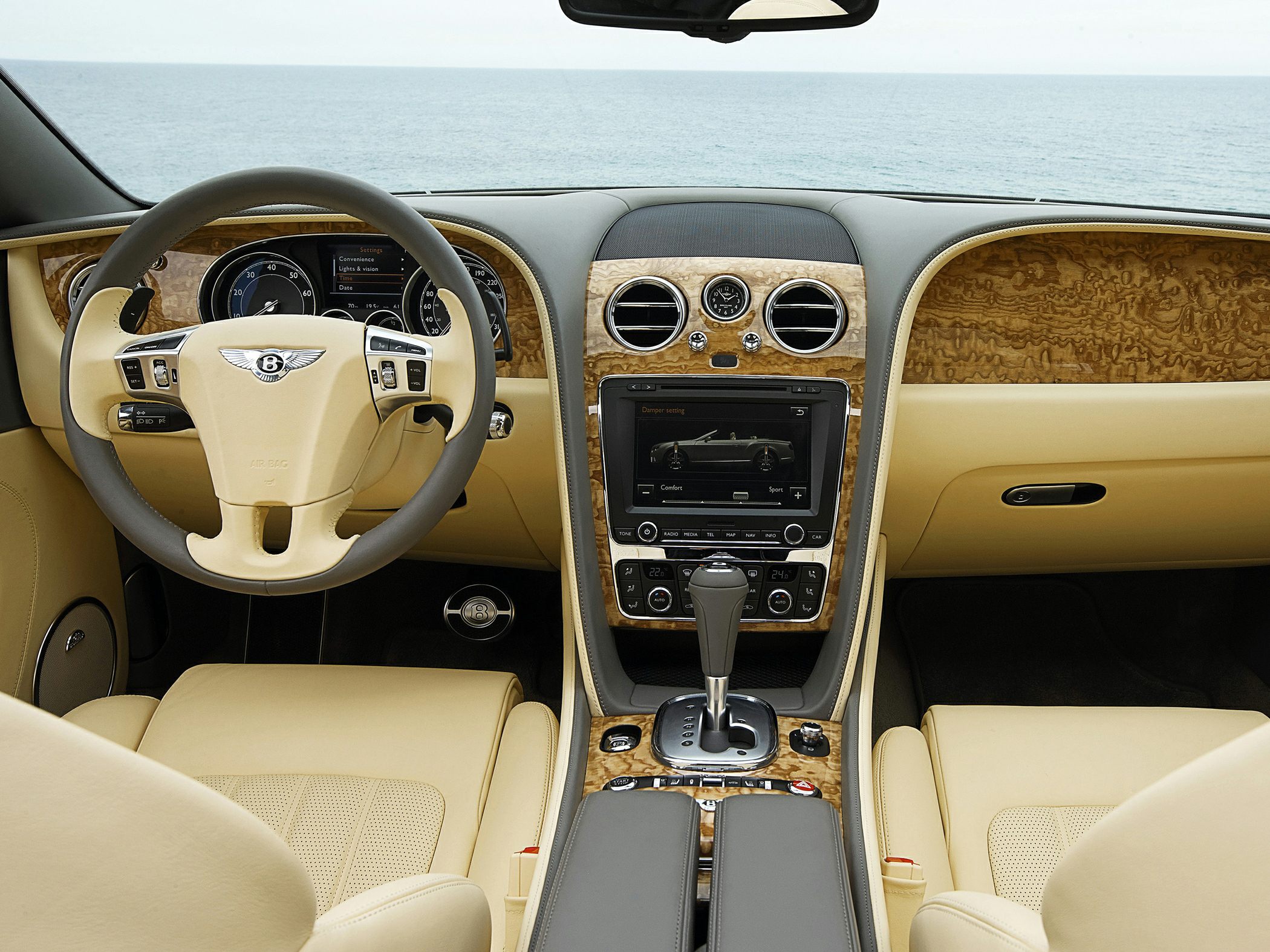 Beige leather interior with wood trim, digital display, and analog clock