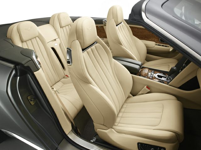 Beige leather seats with wood trim and luxury convertible interior