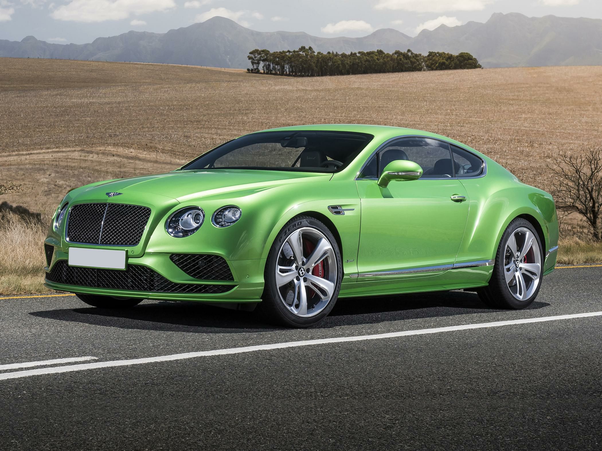 Glossy green luxury coupe with large grille and dual round headlights