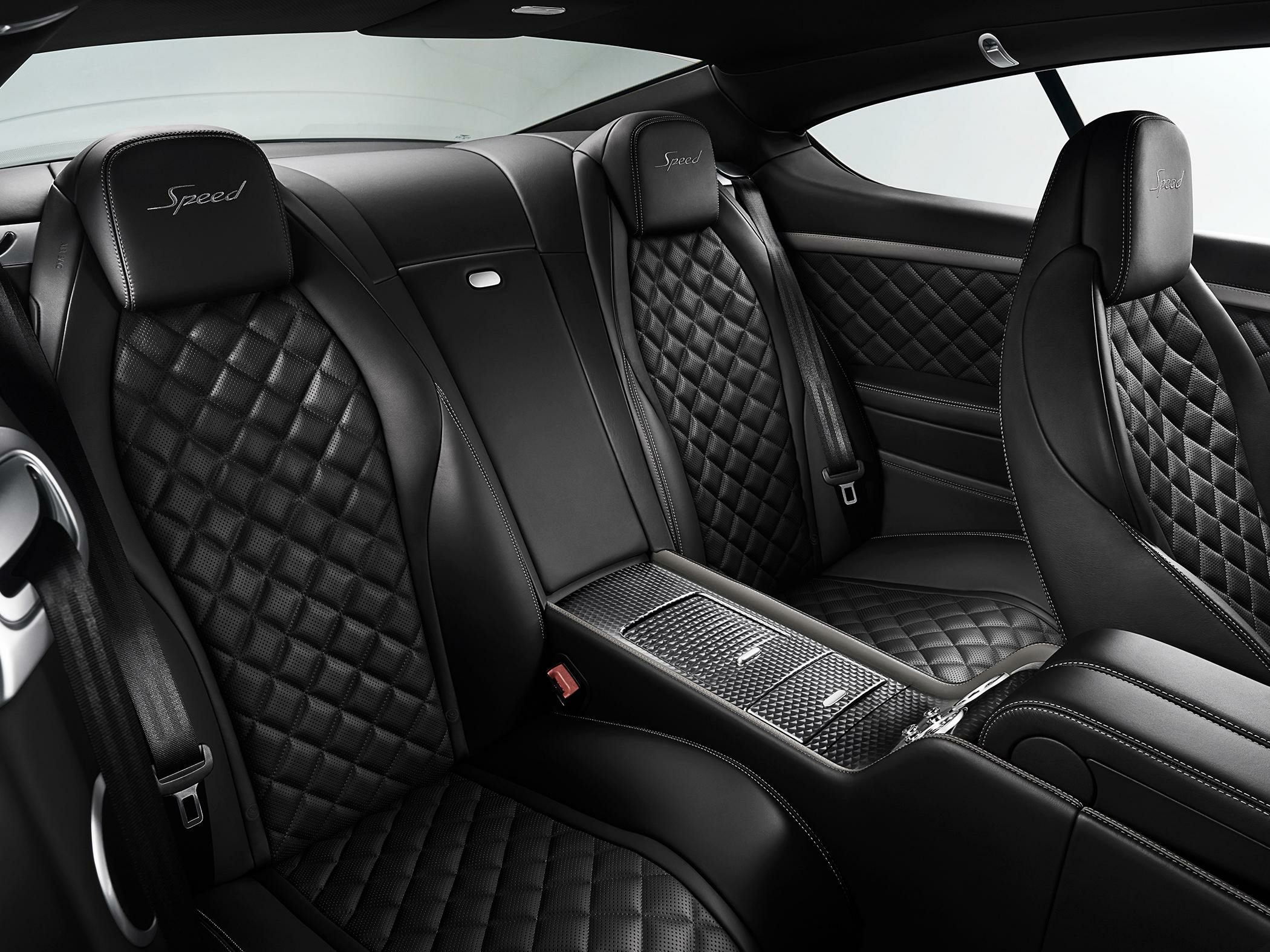 Quilted black leather rear seats with Speed embossed headrests and central console.