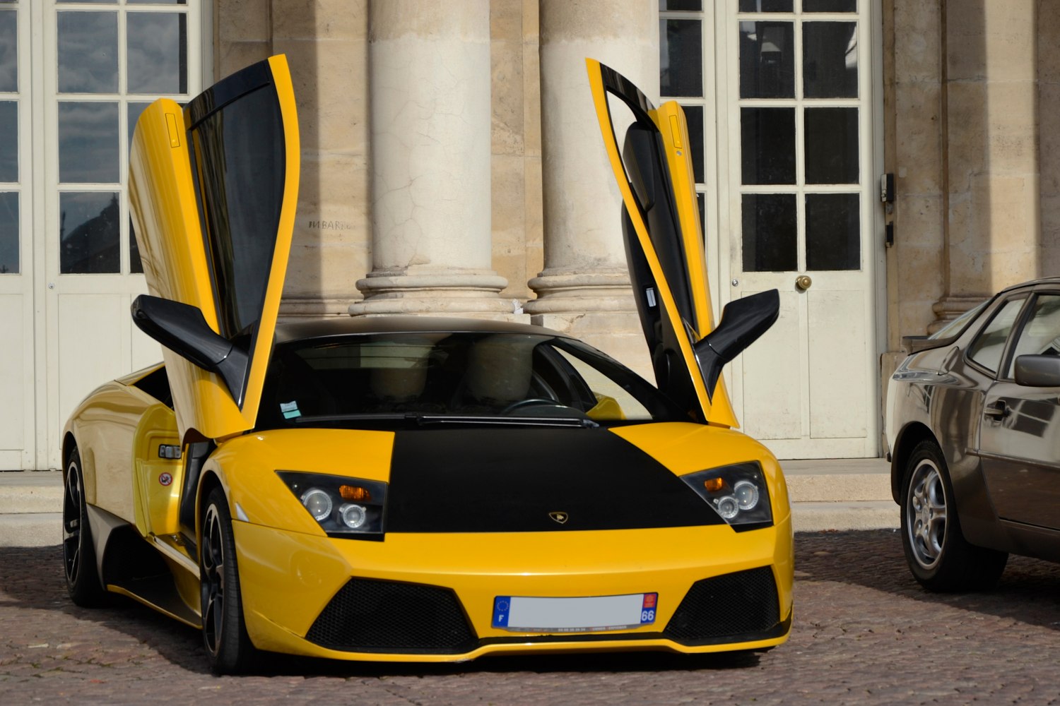 Yellow sports car front view with butterfly doors open