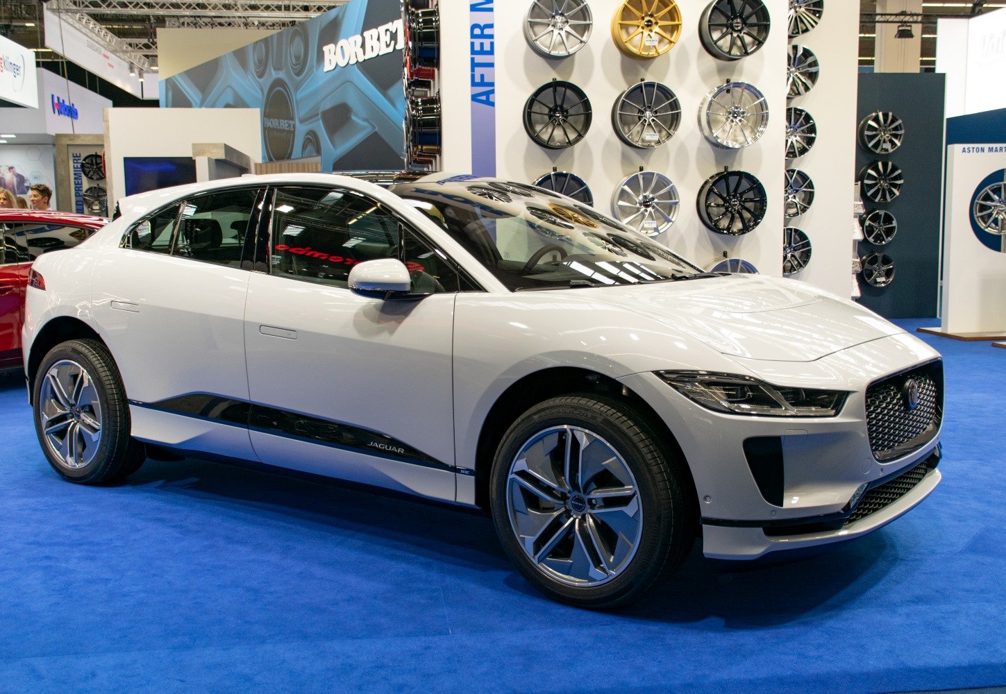Front side view of a sleek electric SUV with distinctive alloy wheels.