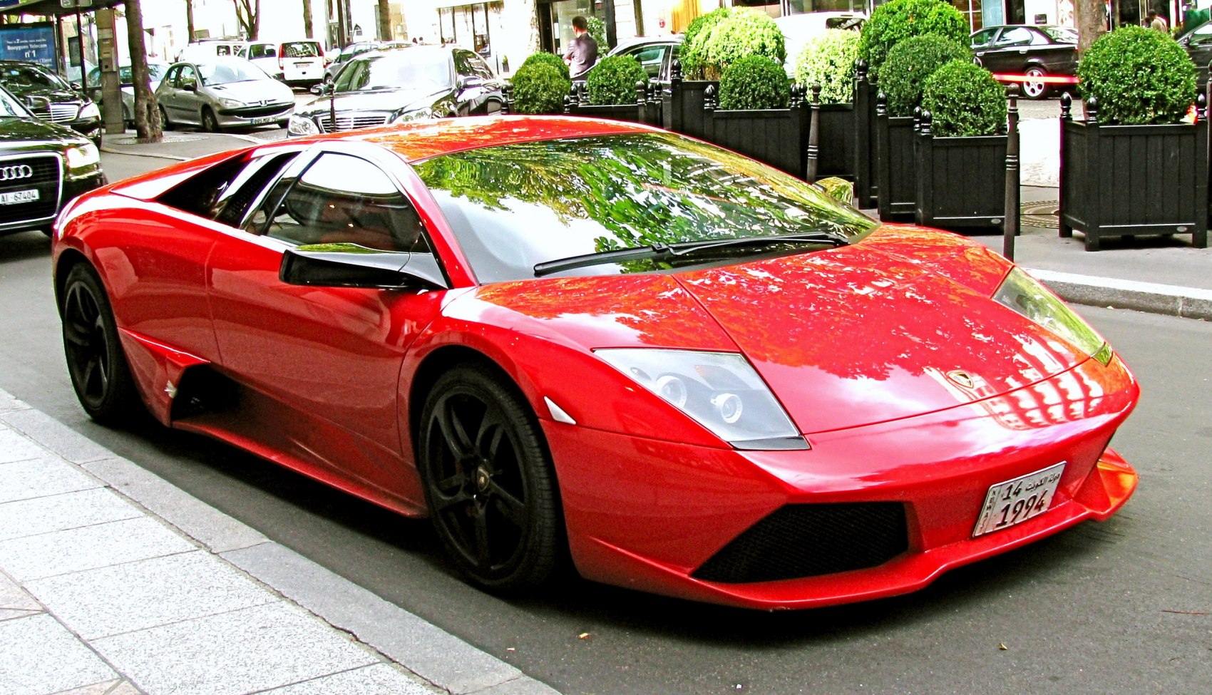 Red aerodynamic sporty coupe with black wheels and low stance