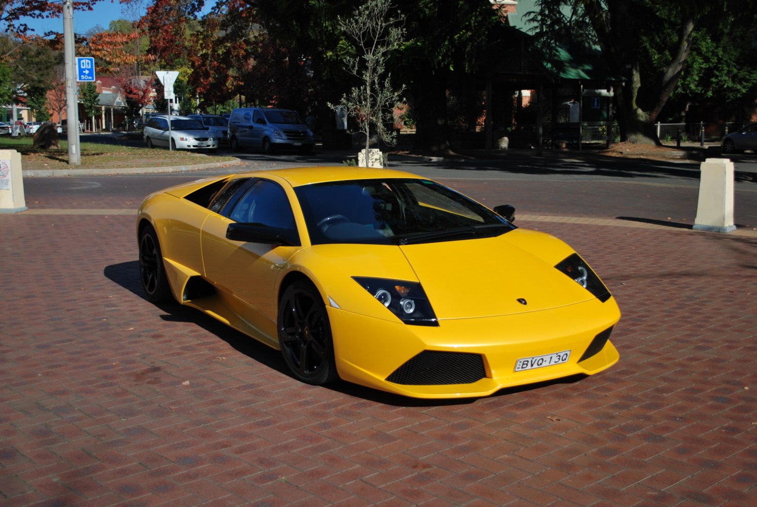 Yellow sports car with angular headlights and low aggressive stance