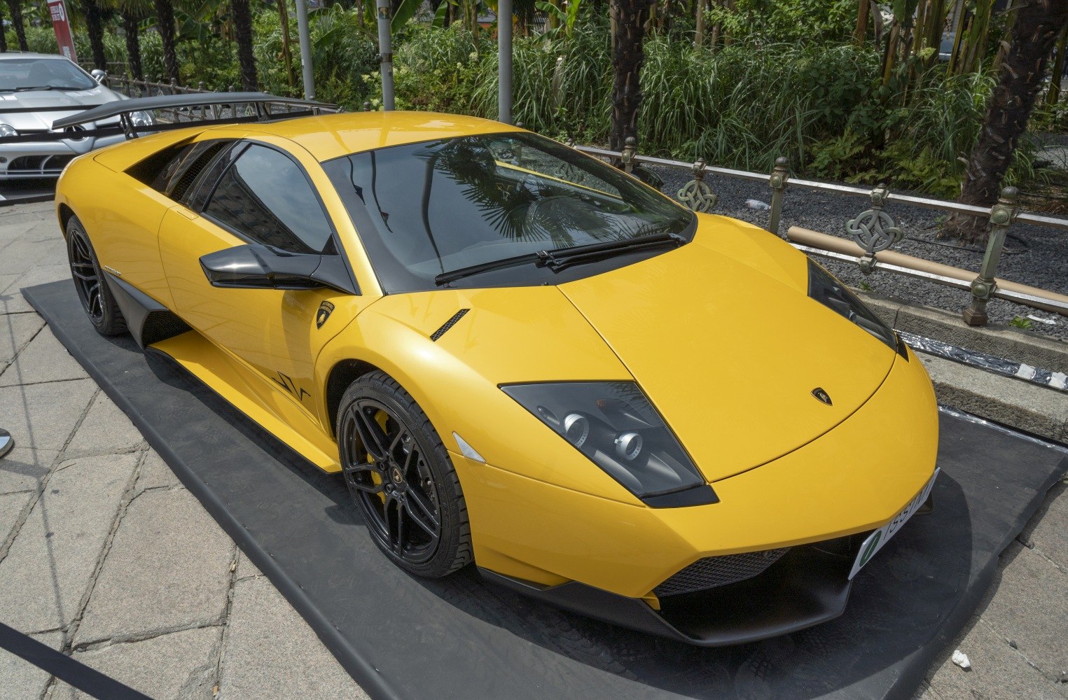Yellow sports car with black wheels and aerodynamic vents