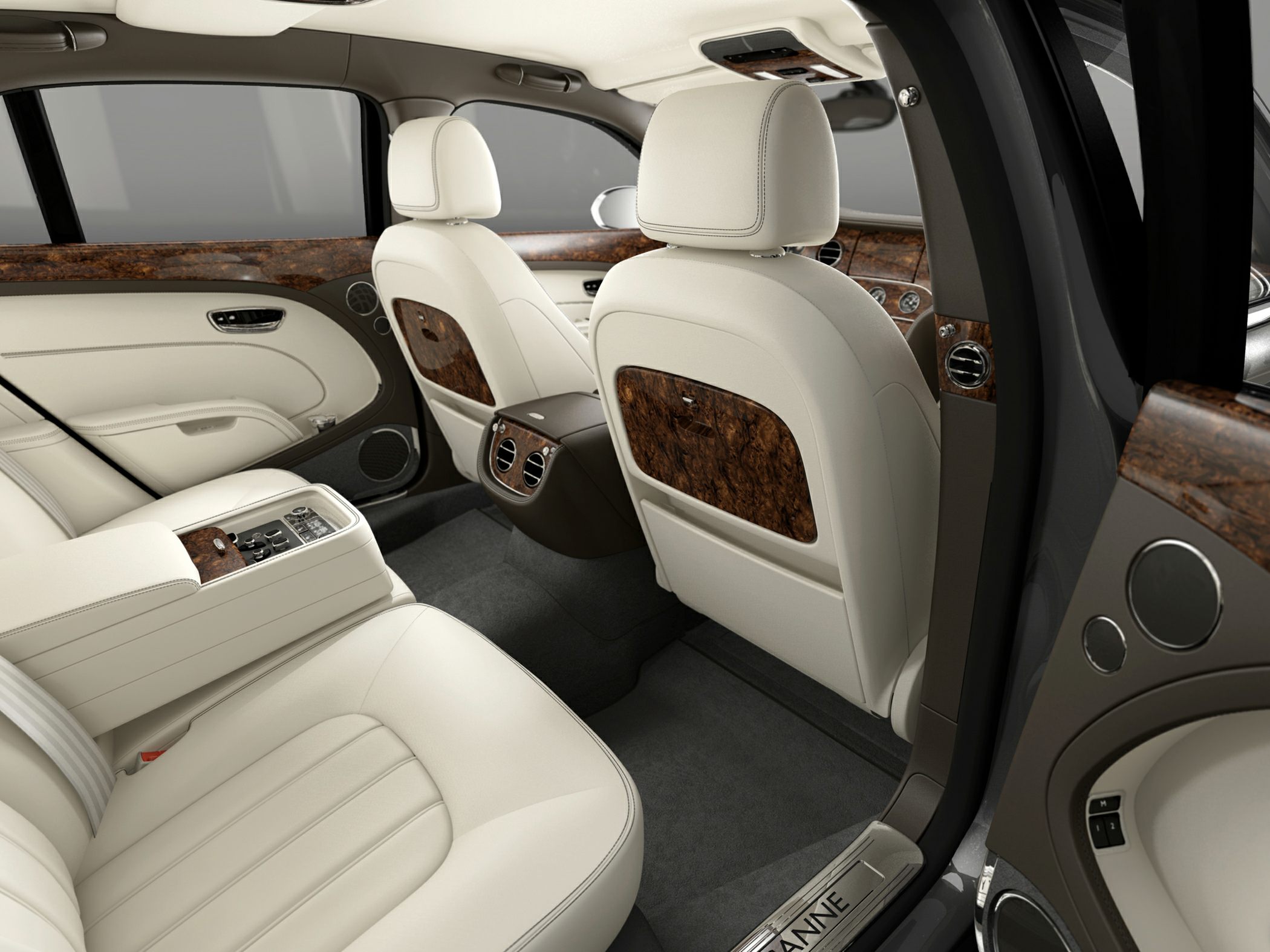 Luxury car interior with wood trim and cream leather upholstery